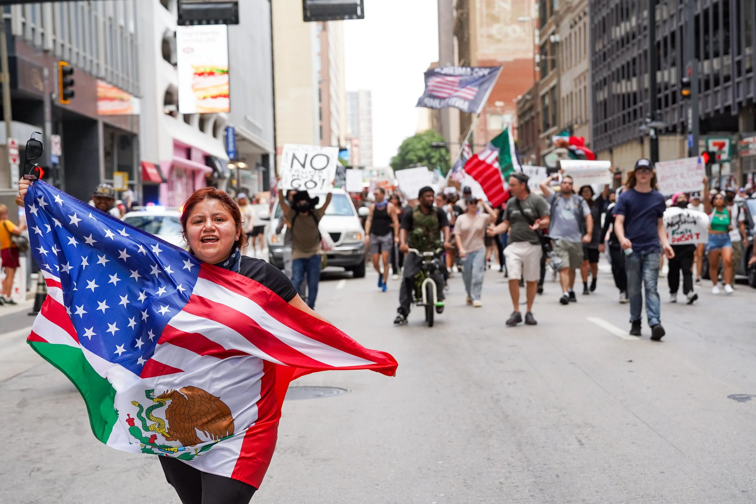 A demonstrator waves a Mexican-American flag during the national No-Kings Day protest in Dallas, Texas June 14, 2025.