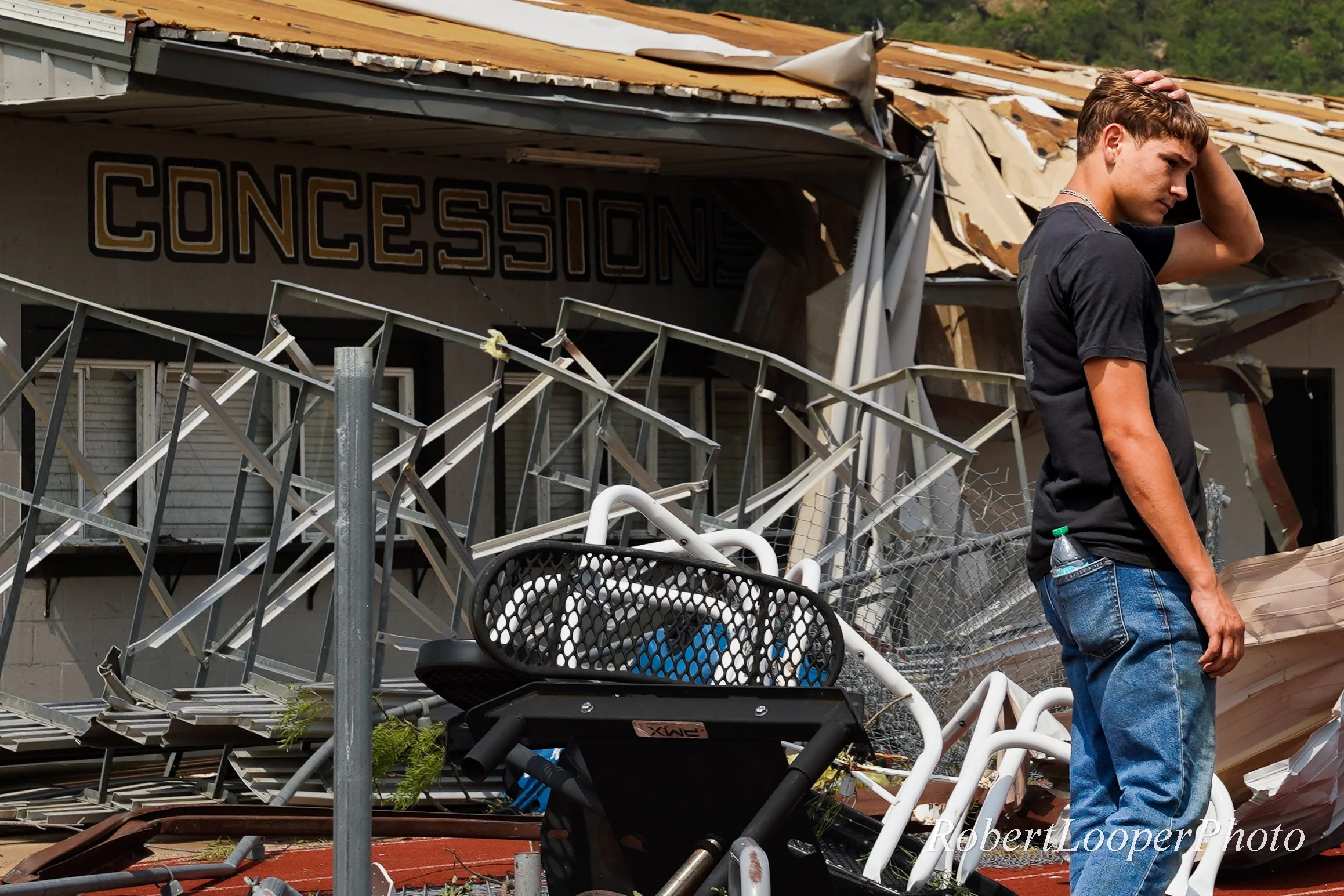 A Gordon High School athlete is surrounded by rubble after the town of Gordon, Texas was hit by an EF-1 tornado the night before, May 19, 2025. The tornado caused significant damage to residential structures in the area, as well as the Gordon High Sc