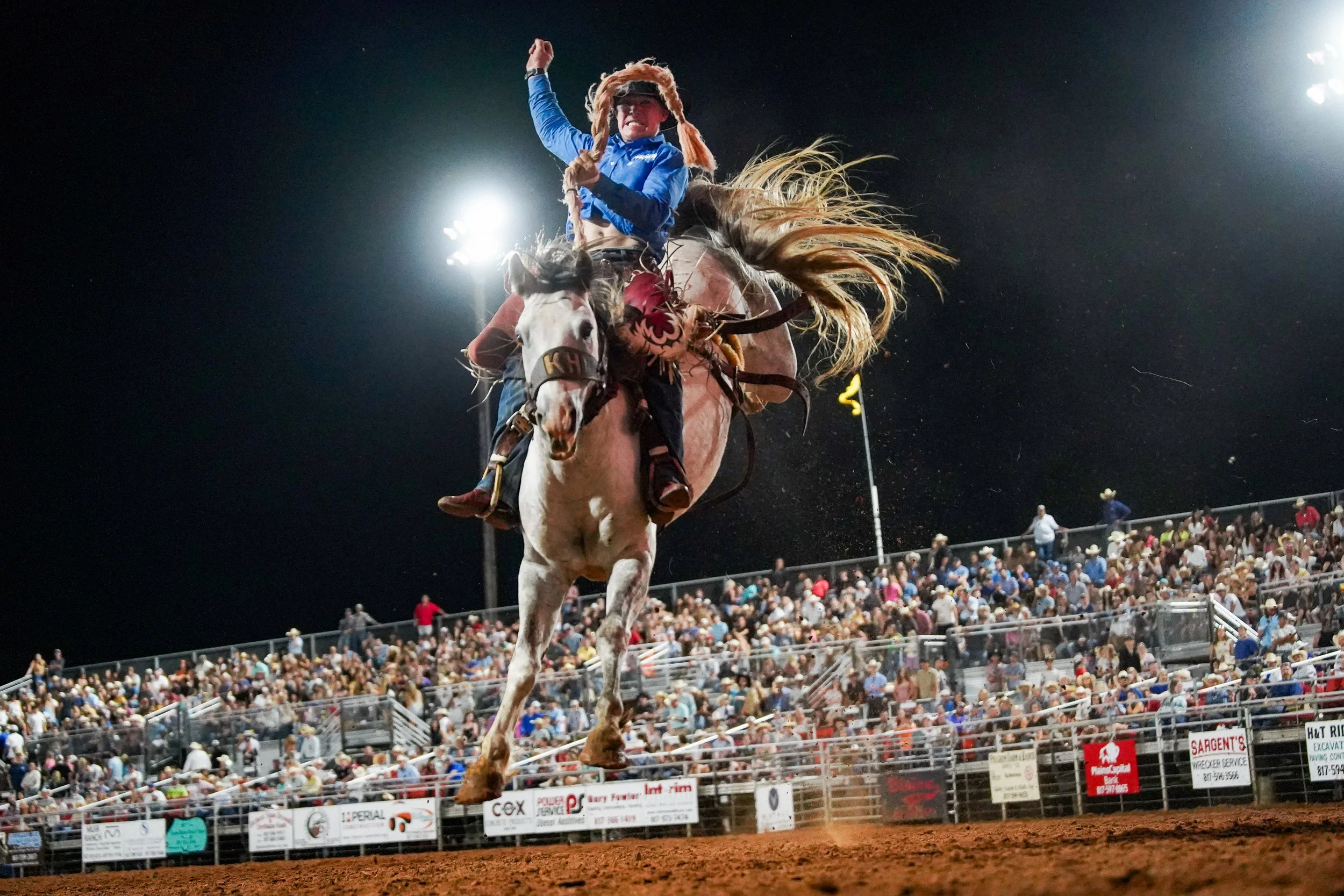 A saddle bronc rider sails through the air during the saddle bronc riding event at the Parker County Sheriffs Posse Rodeo hosted in the PCSP Rodeo Arena in Weatherford, Texas June 13, 2025.