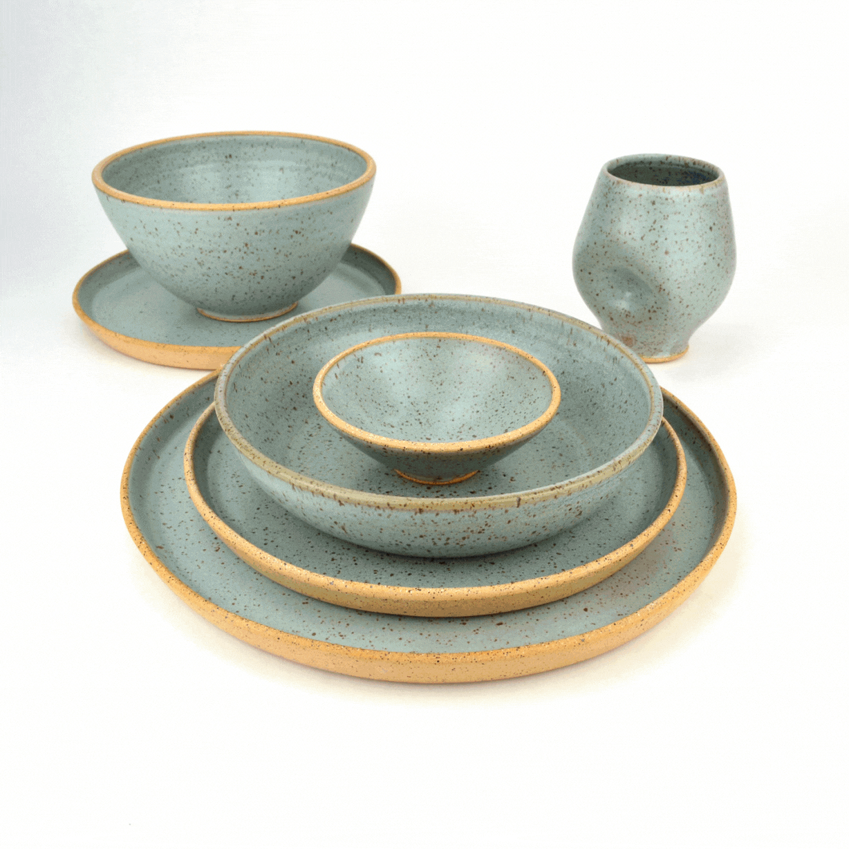 Photos of plates, cups, and bowls thrown by Schyler of Schyler the Potter
