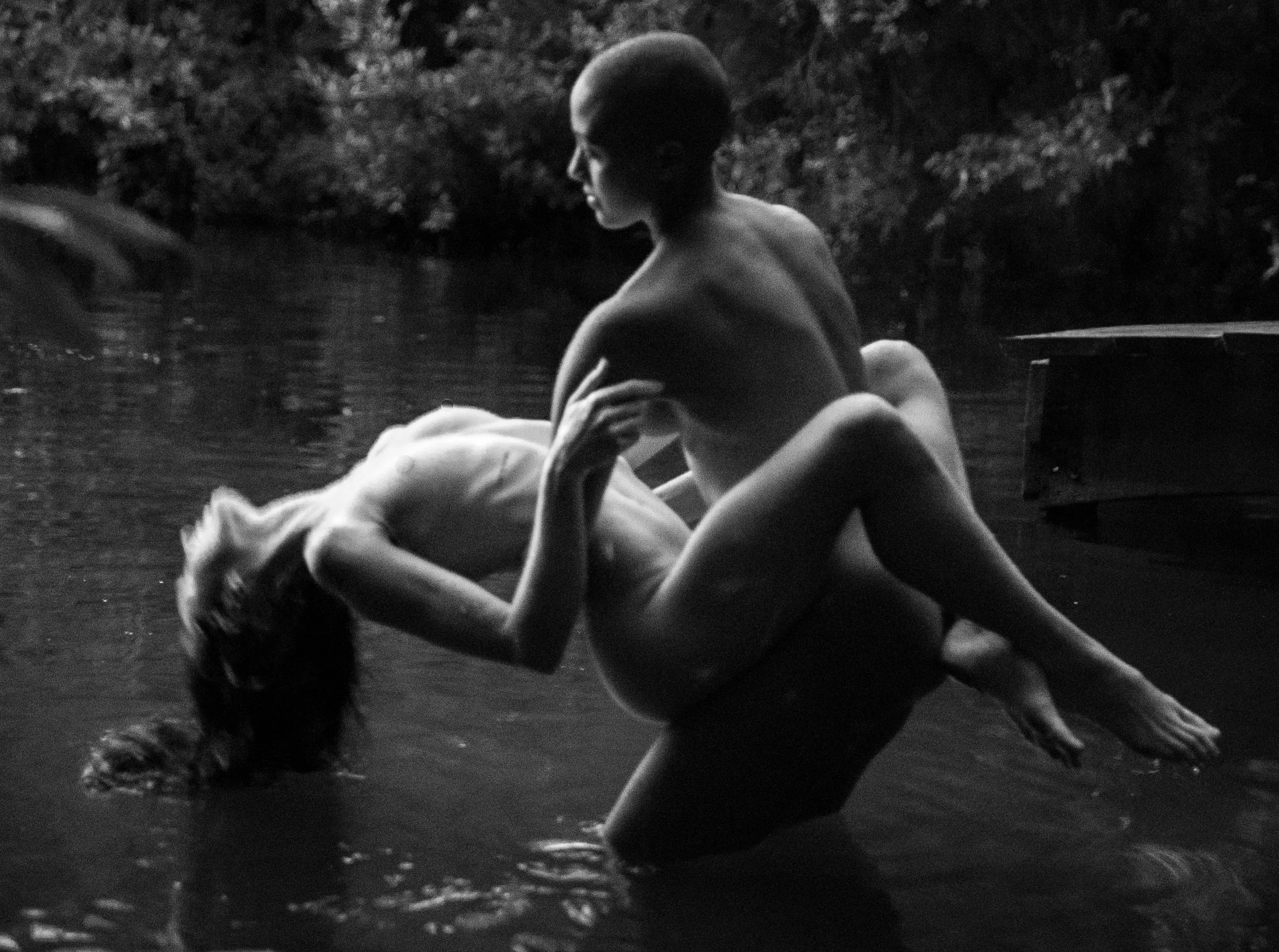 Two figures in the  water, black and white fine-art study.