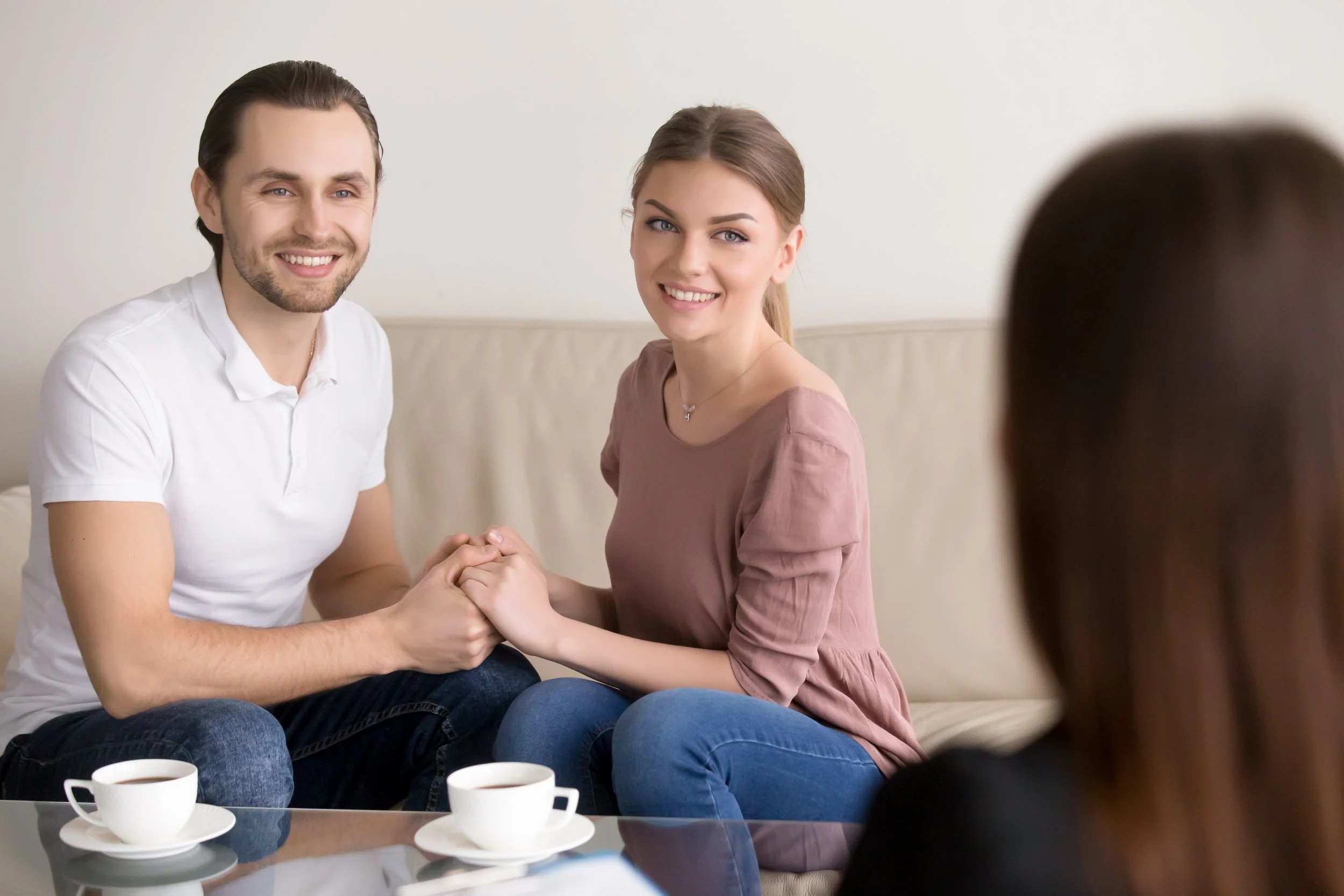 cheerful-young-family-couple-consultation-holding-hands-smiling.jpg