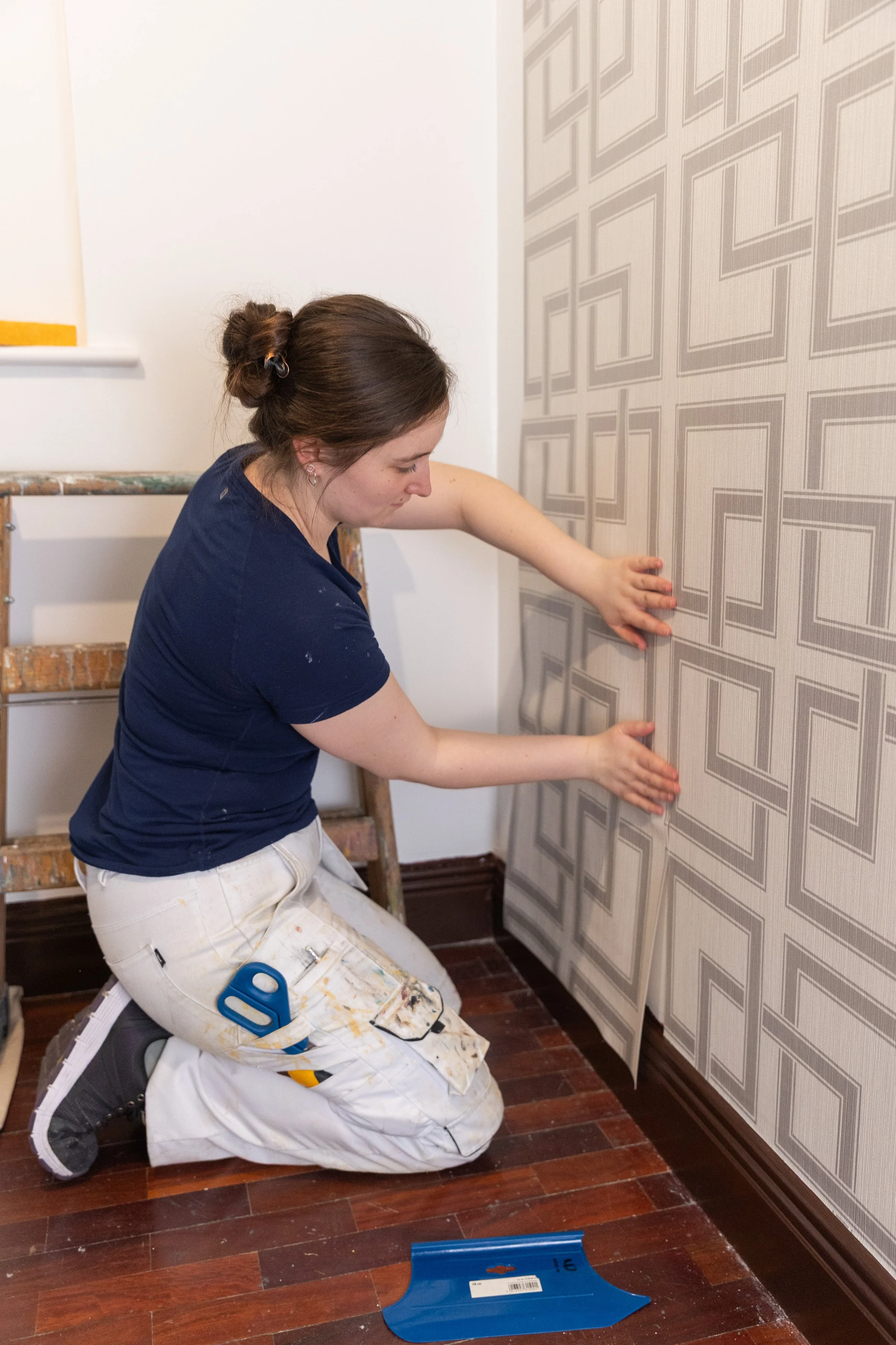 female wallpapering
