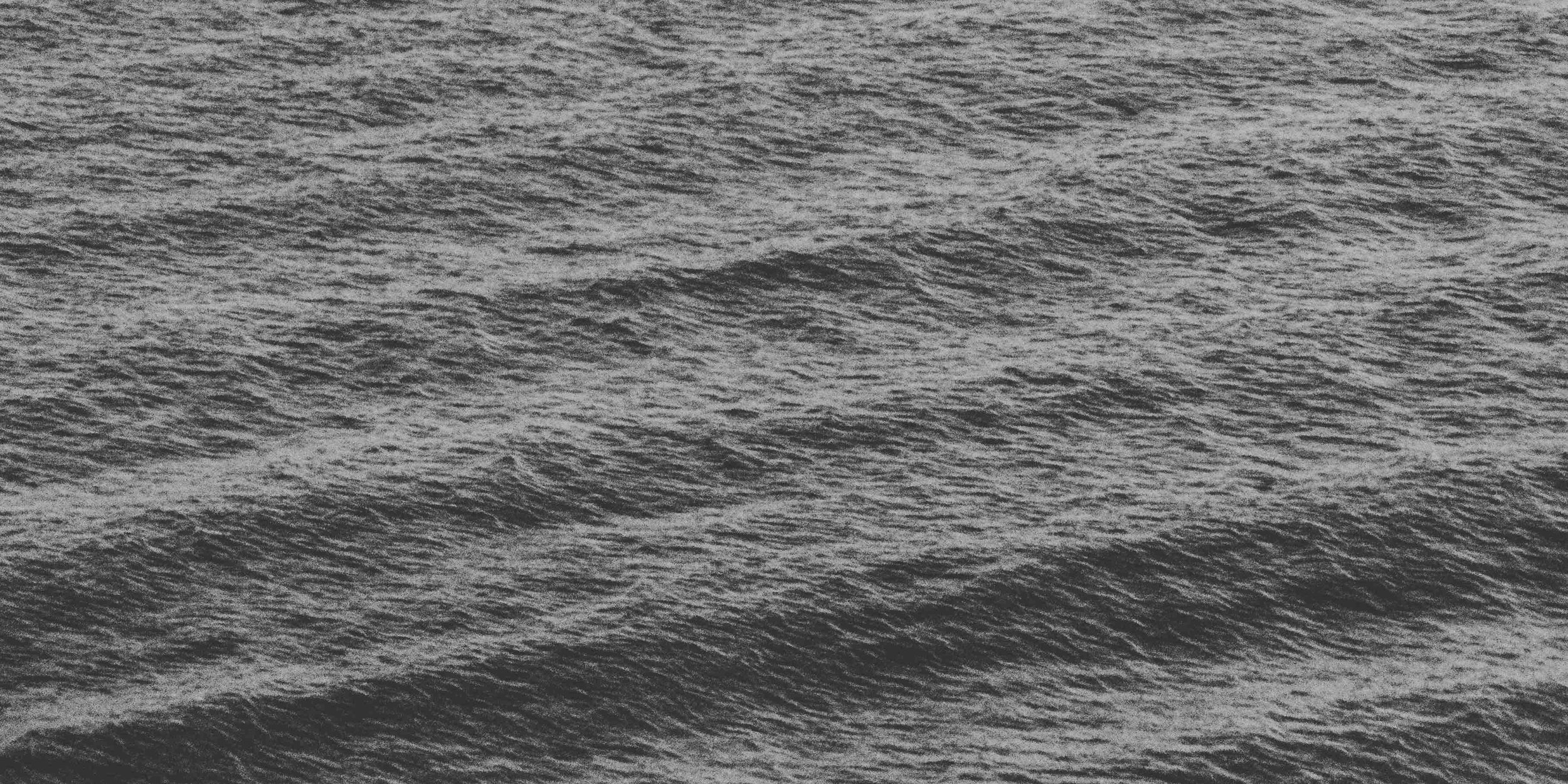 Monochrome image of ocean waves in motion.