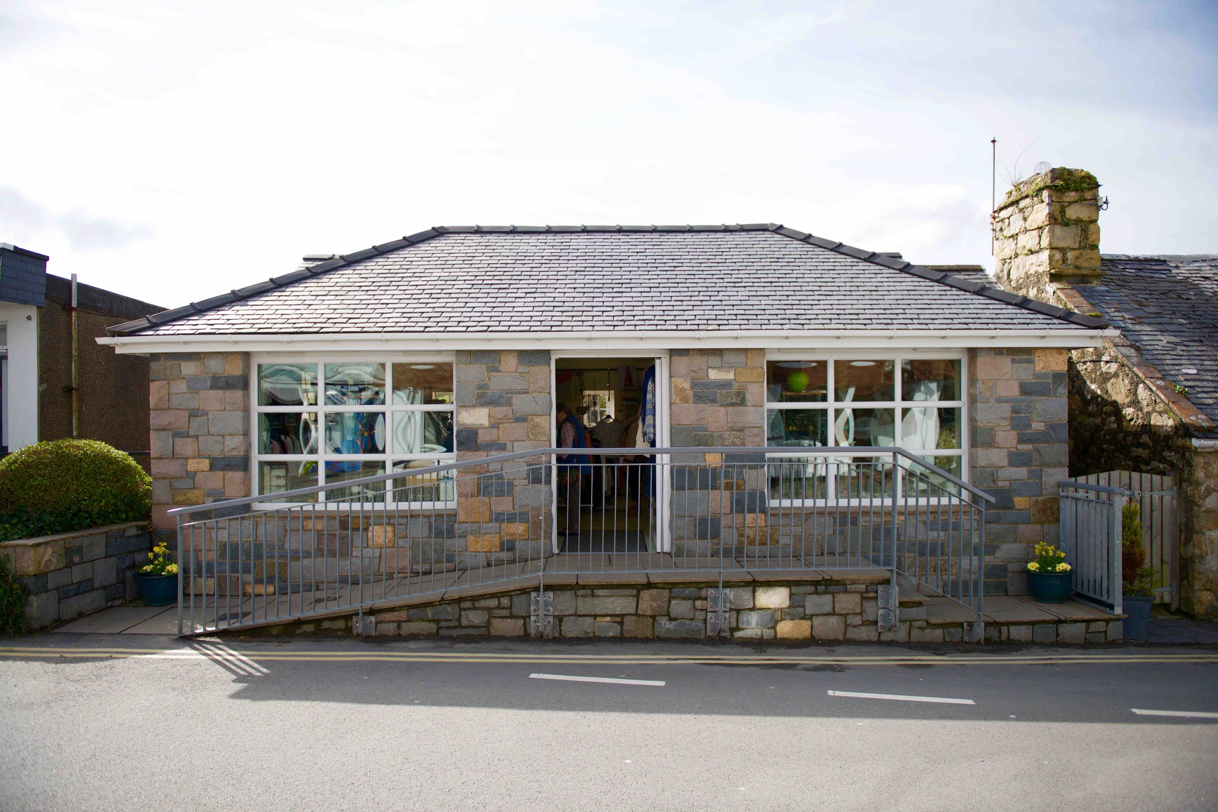 Stone building with front porch and ramp