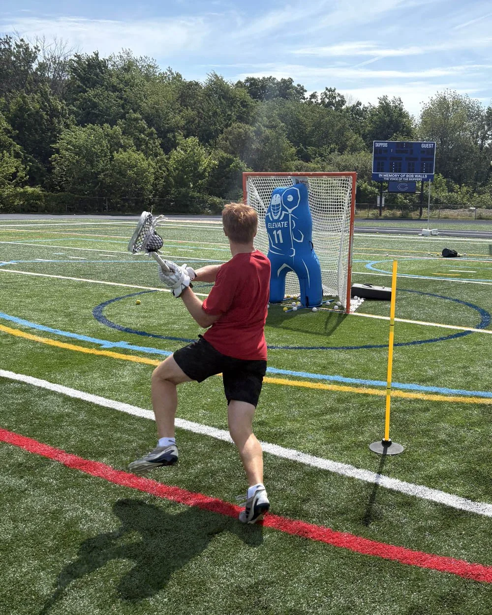 Youth lacrosse player training solo with Elevate goalie dummy during Big Rock Lacrosse clinic.jpg