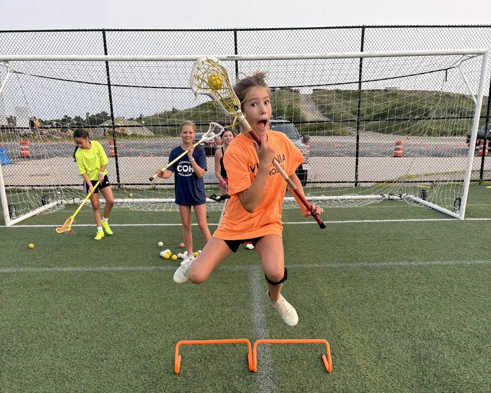 Youth lacrosse athlete mid-air during agility hurdle drill at Big Rock Lacrosse camp.jpg