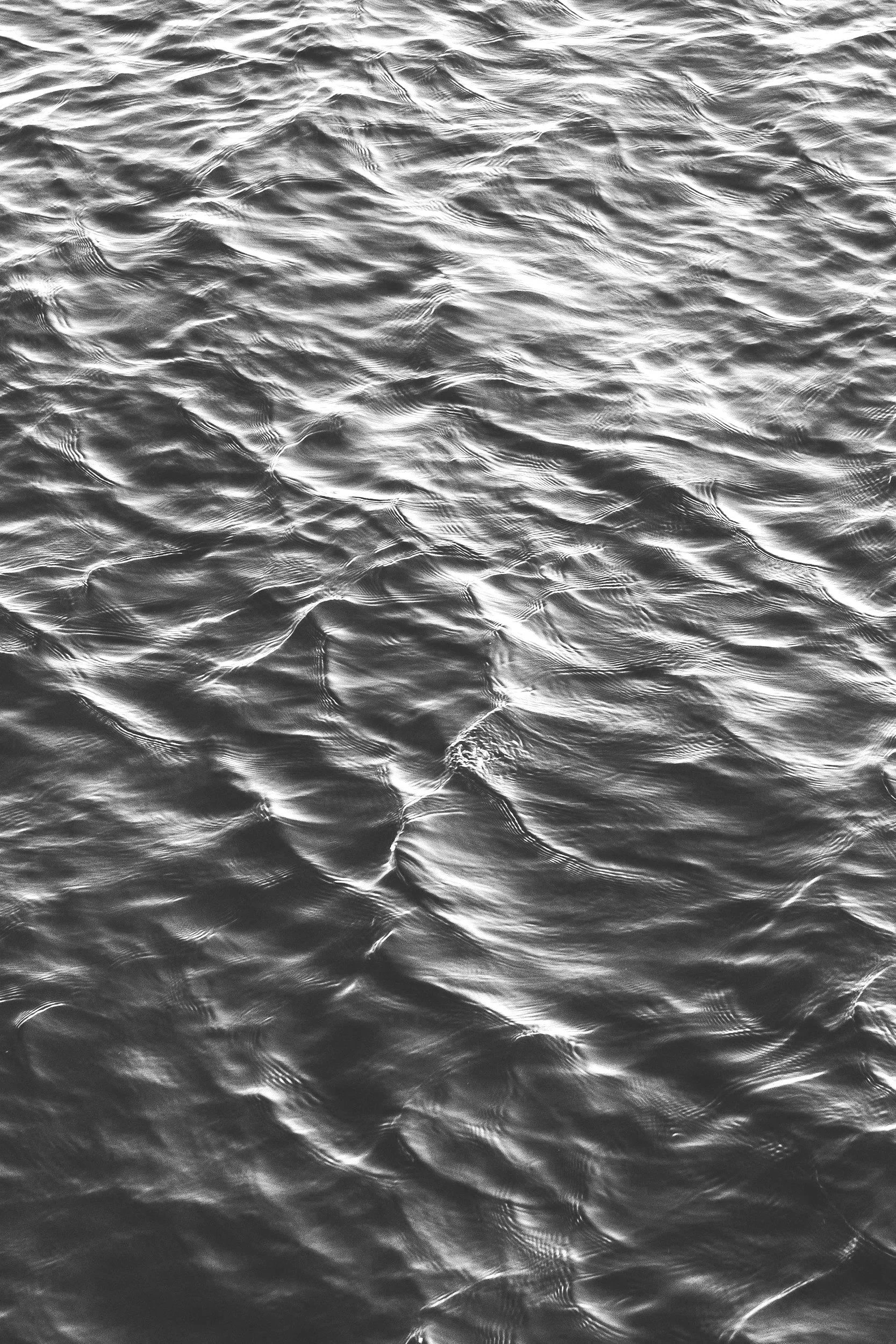 Close-up of rippling water with light reflections.