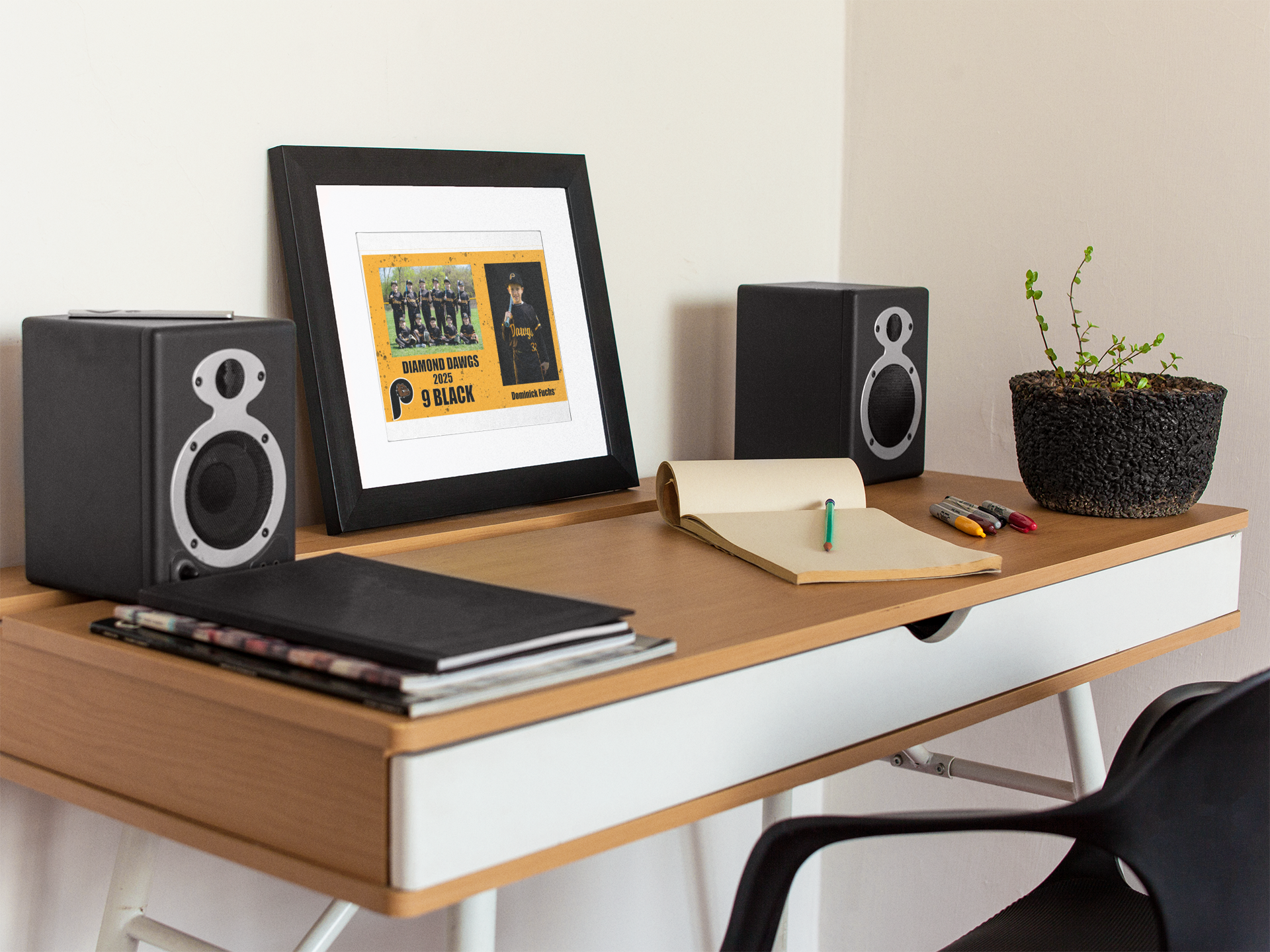 art-print-mockup-on-a-black-frame-lying-on-a-wooden-desk-near-speakers-a14691.png