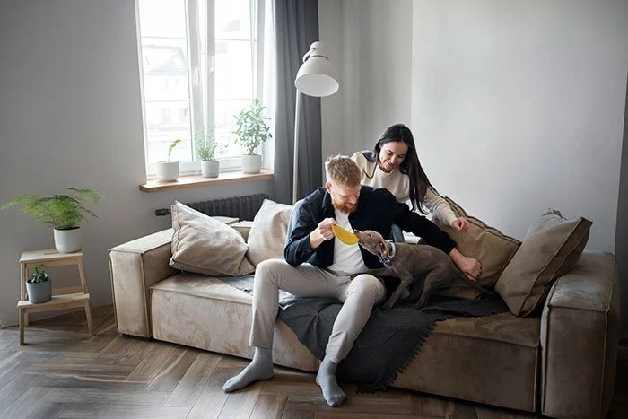 full-shot-couple-with-cute-dog-home.jpg