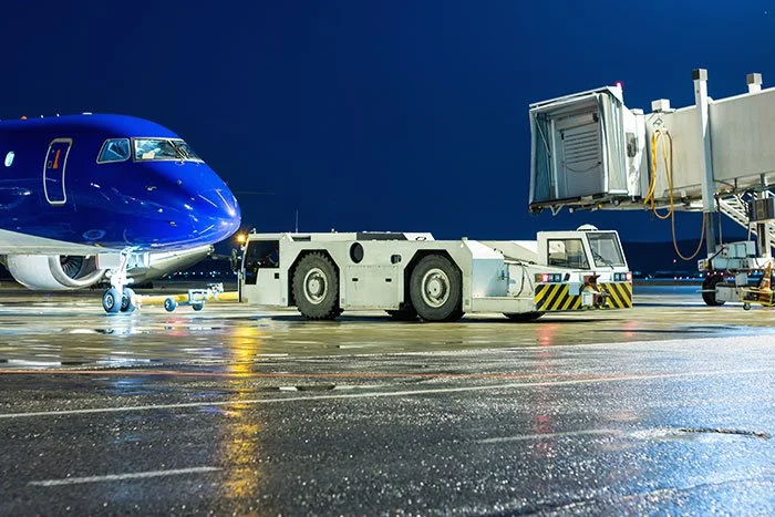 tow-tractor-rolls-back-passenger-airplane-from-air-bridge-night-airport-apron.jpg