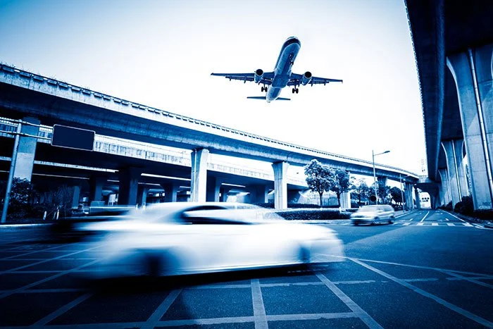 blurred-street-scene-city-with-plane-flying.jpg