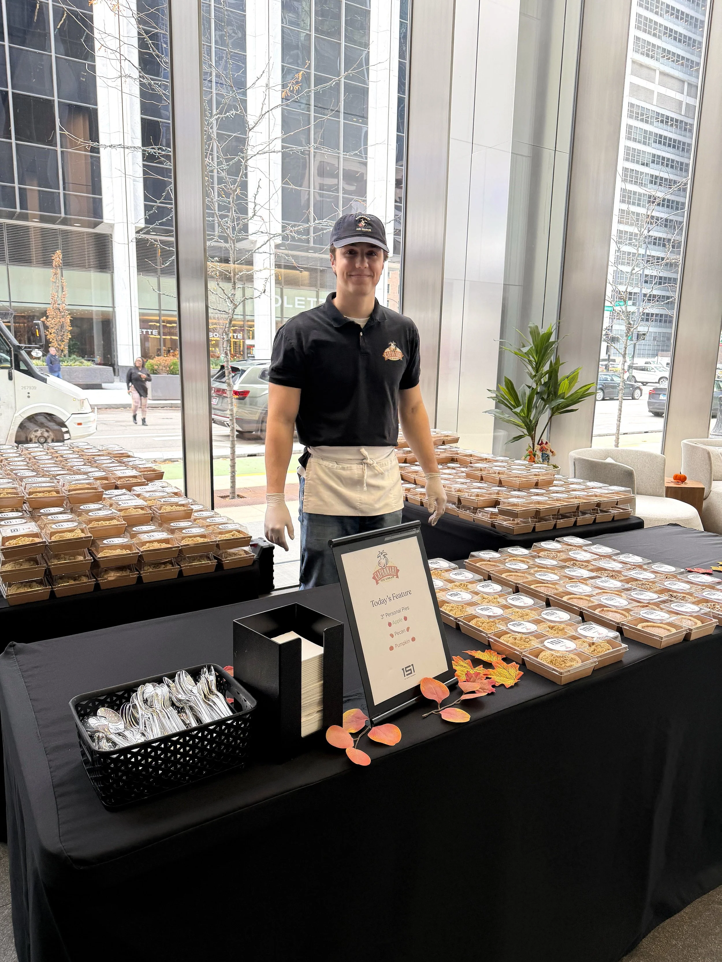 tables with stacks of individually wrapped 3 inch pies