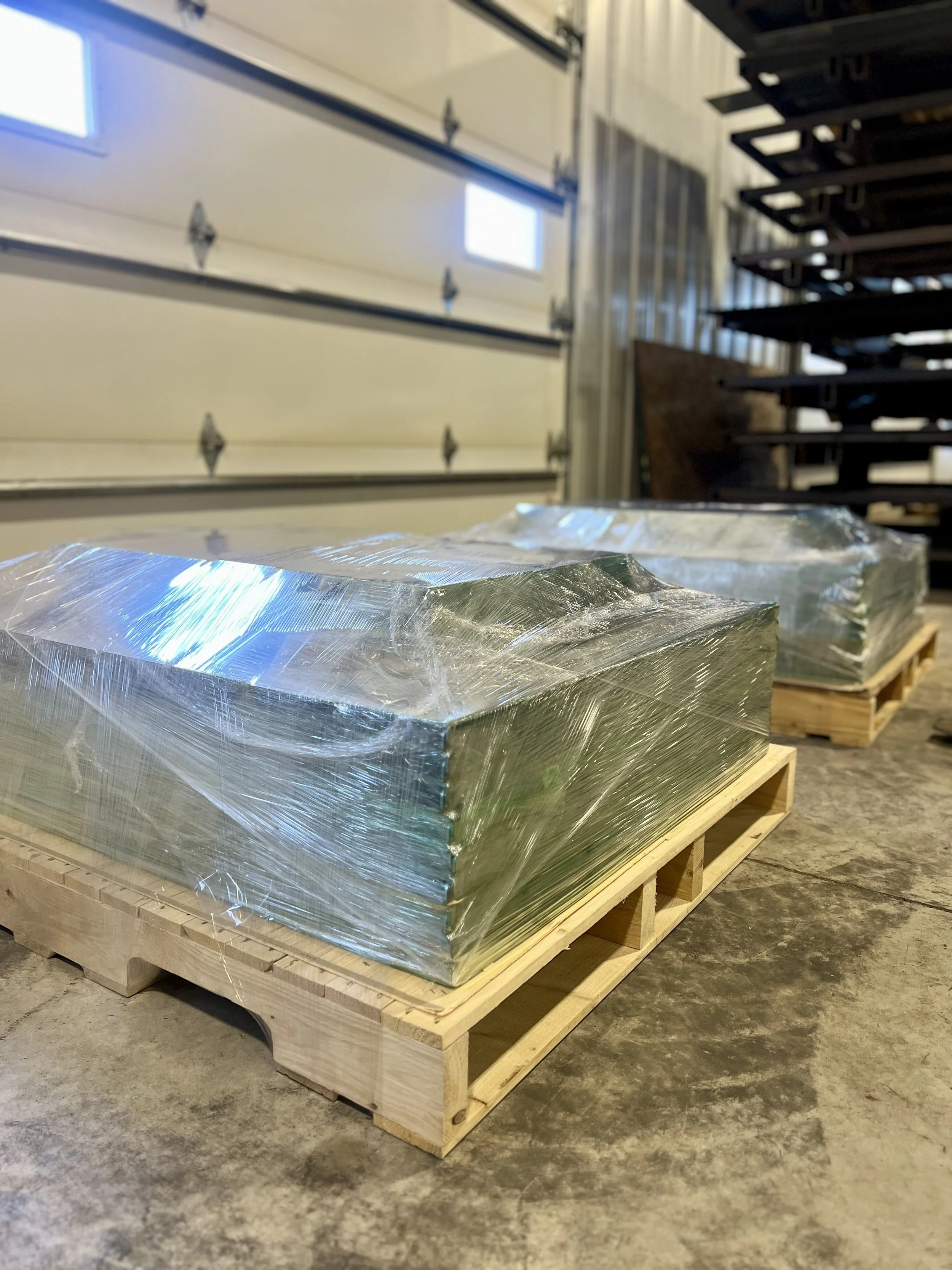 Pallets of laser-cut and formed metal components produced for OEM manufacturing runs.