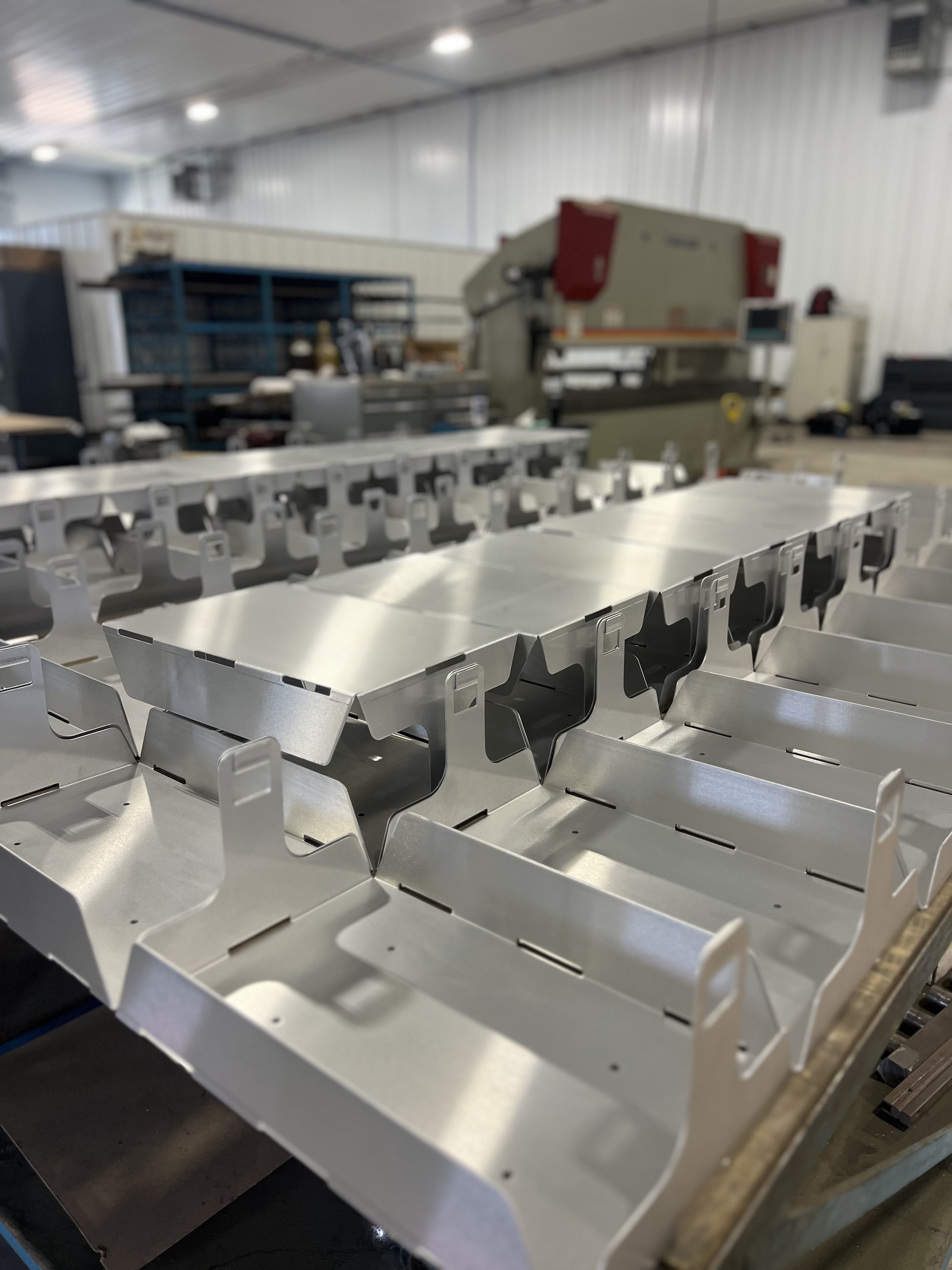 Laser-cut and formed stainless steel production parts manufactured by Fine-Line Fabrications for OEM customers.