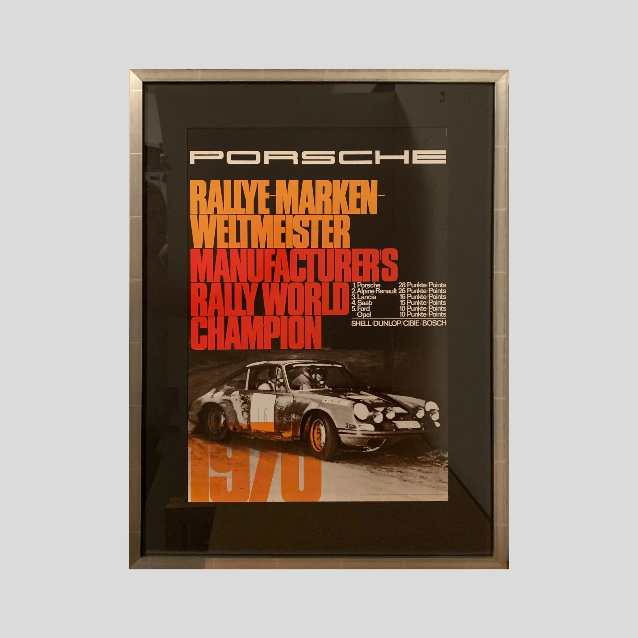 An original Porsche rally poster from the 1970s in a custom, silver-leafed archival frame. 