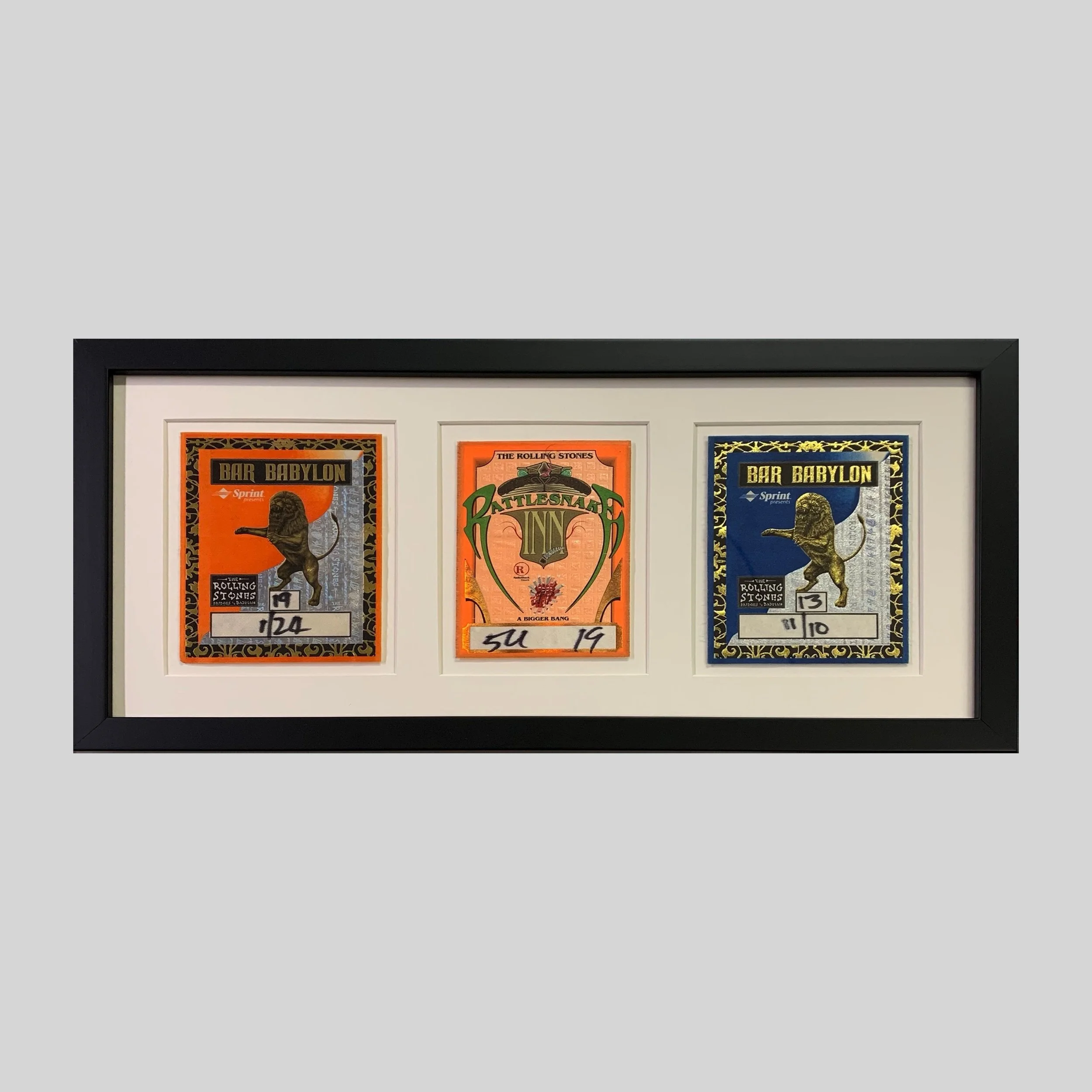 Three vintage Rolling Stones "all-access" passes displayed together in a custom, three-window archival frame. 
