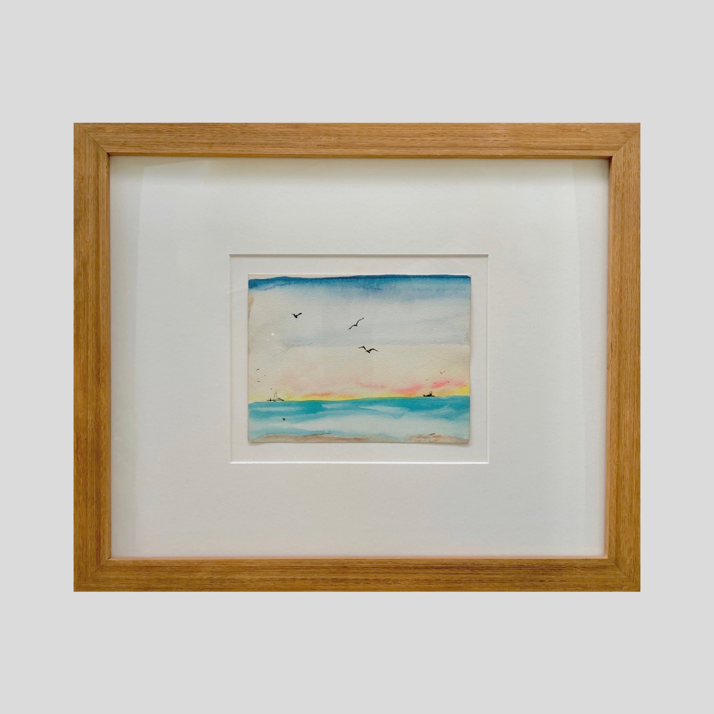 A small vintage watercolor of a beach scene timelessly displayed and preserved in a hand-crafted beech wood frame. 