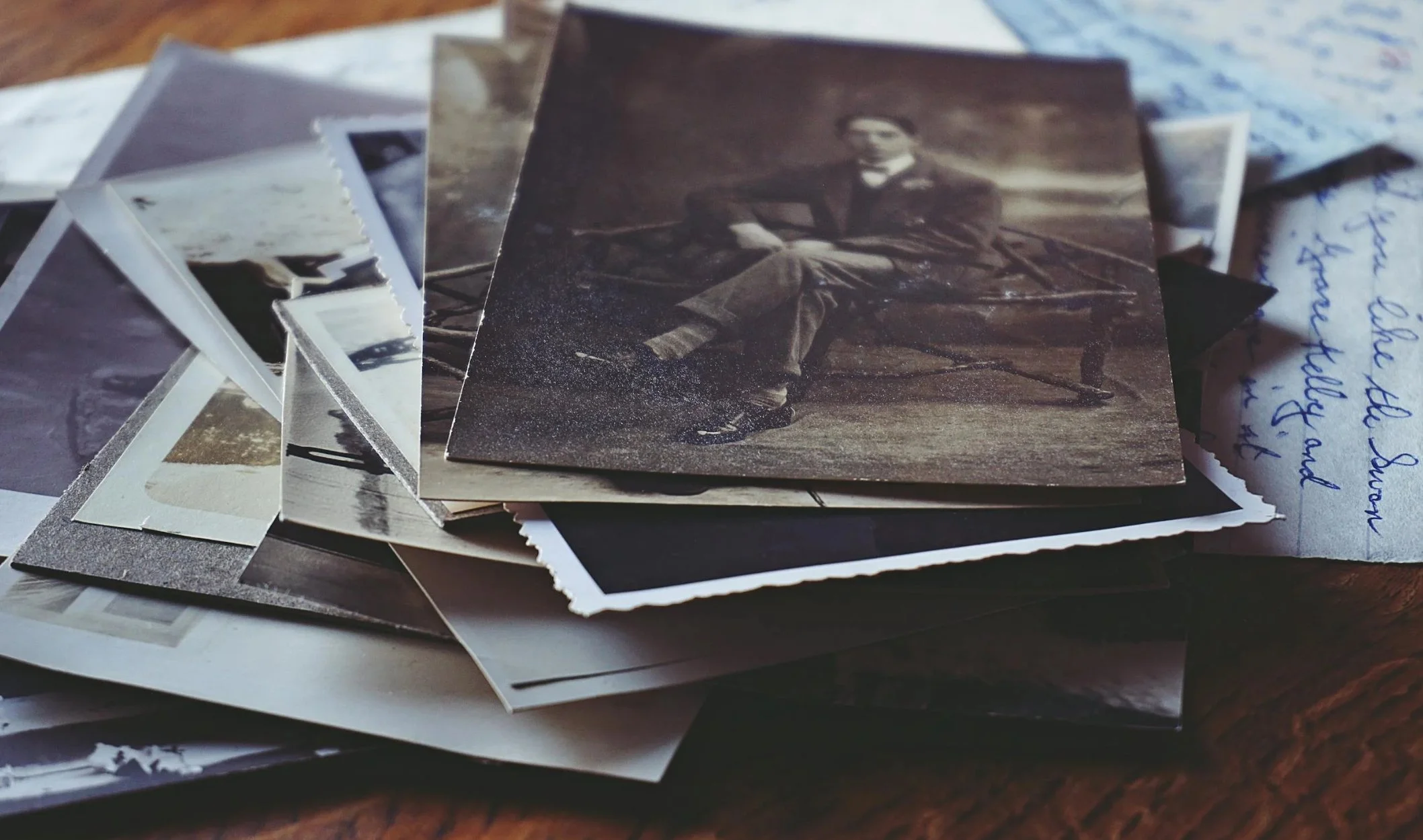Old photographs and handwritten notes on an old oak table.