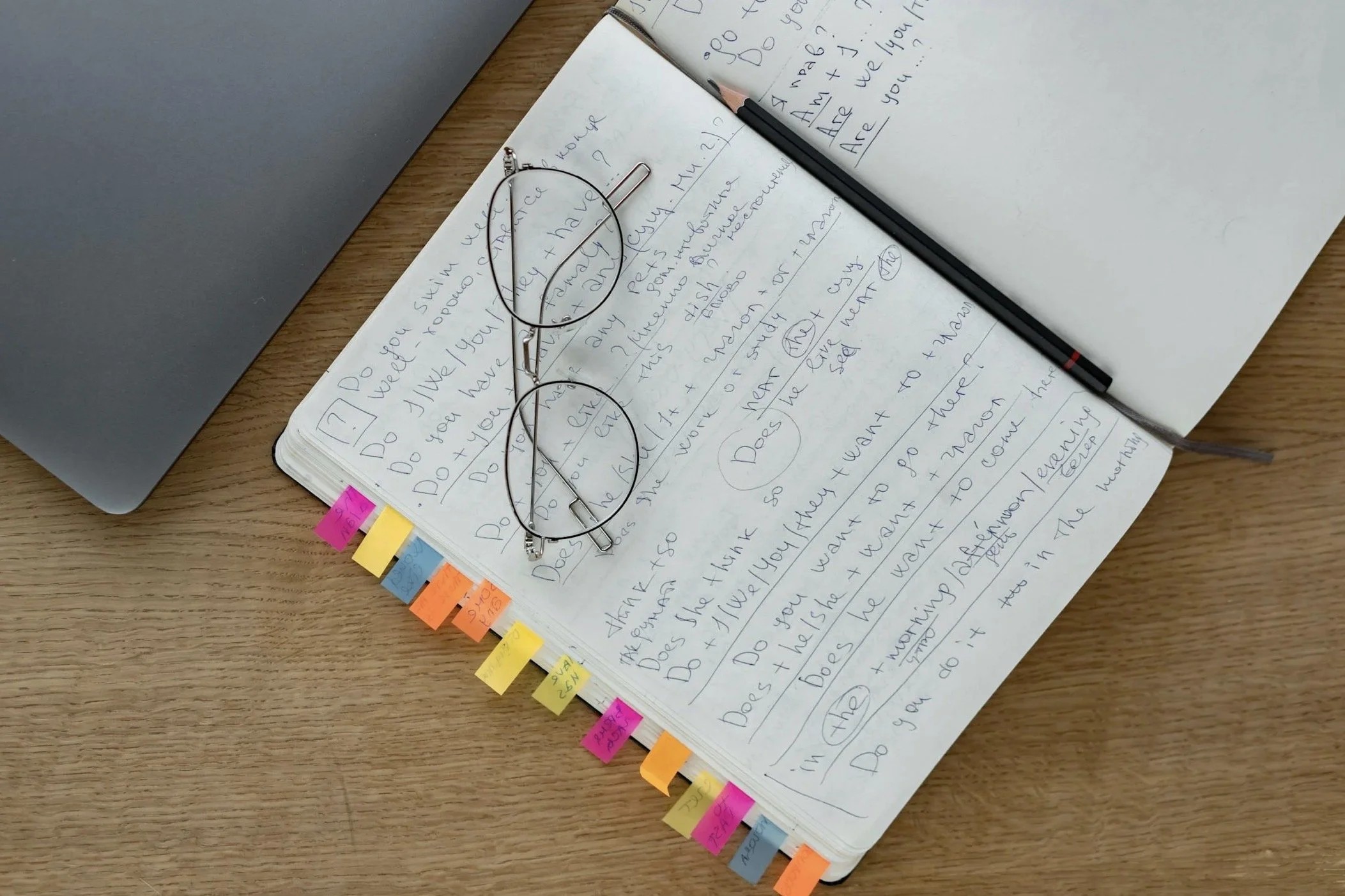 Glasses, an annotated book and a pencil