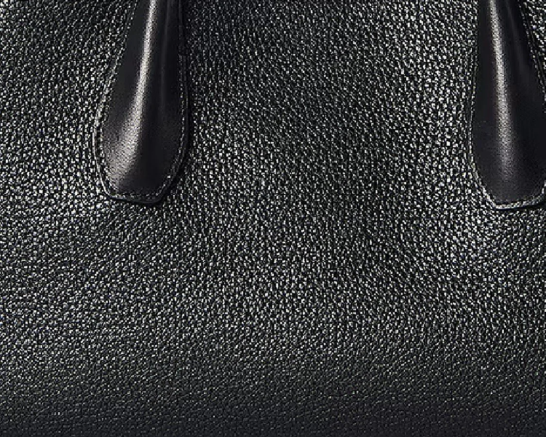 Close-up of the black pebbled leather and handles of The Row Alger shoulder bag