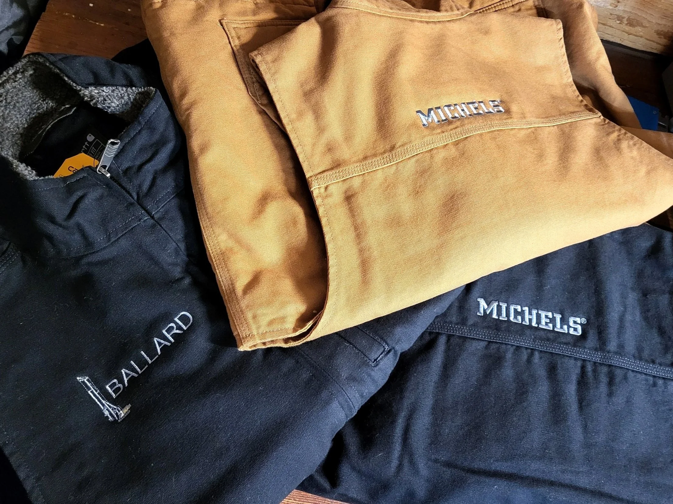 custom logo for michels construction company, ballard drilling rig on the front of a carhartt vest