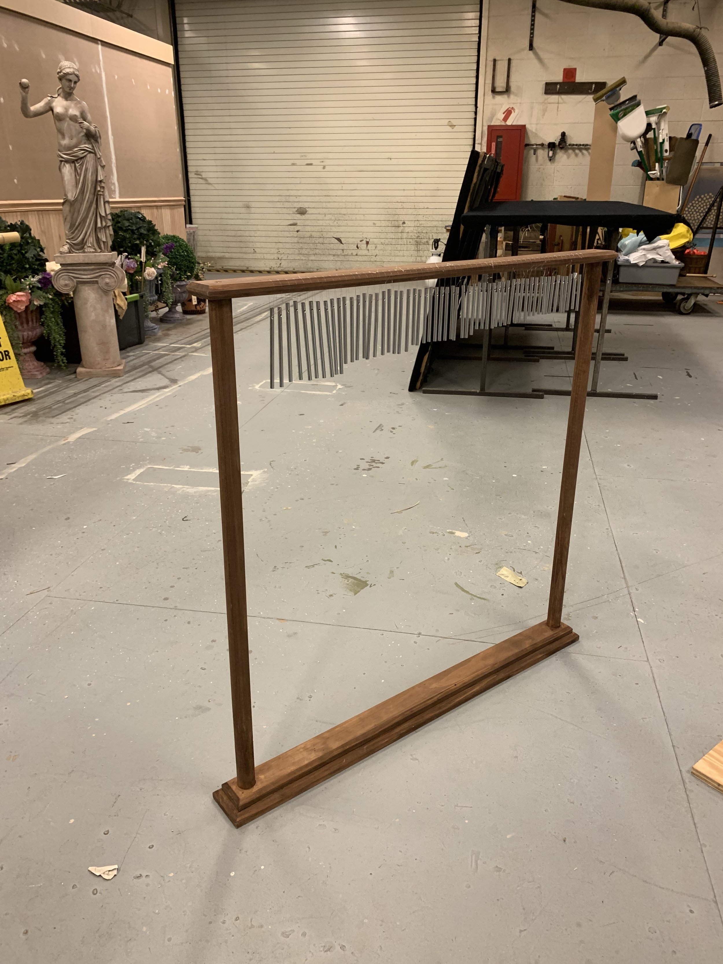 A wooden stand for chime tubes used in a production of Metamorphoses (UMD).
