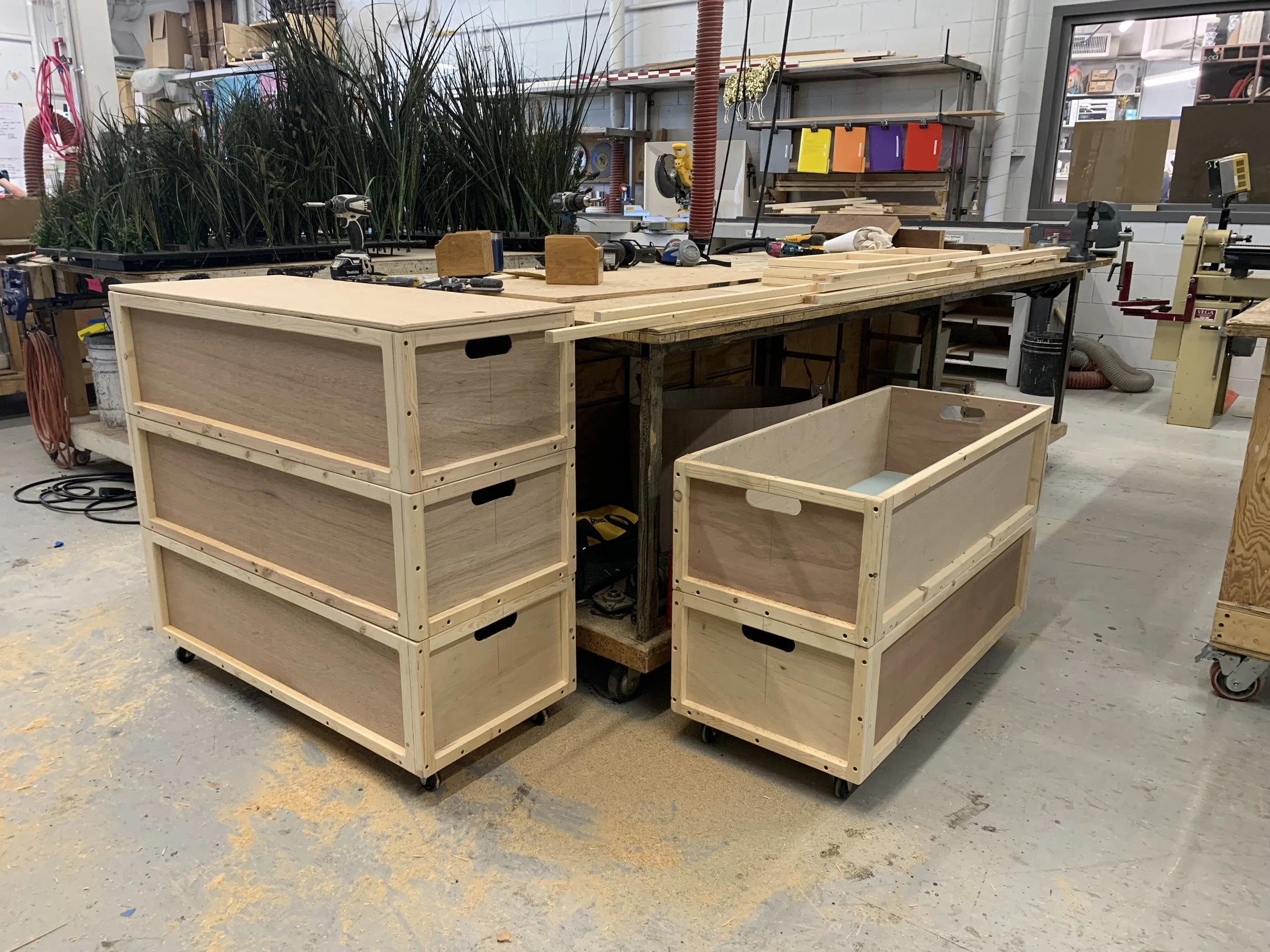 5 of 6 wooden crates for transporting large sconces. The bottom crates are on casters and the stacking crates interlock (The Santa Fe Opera).
