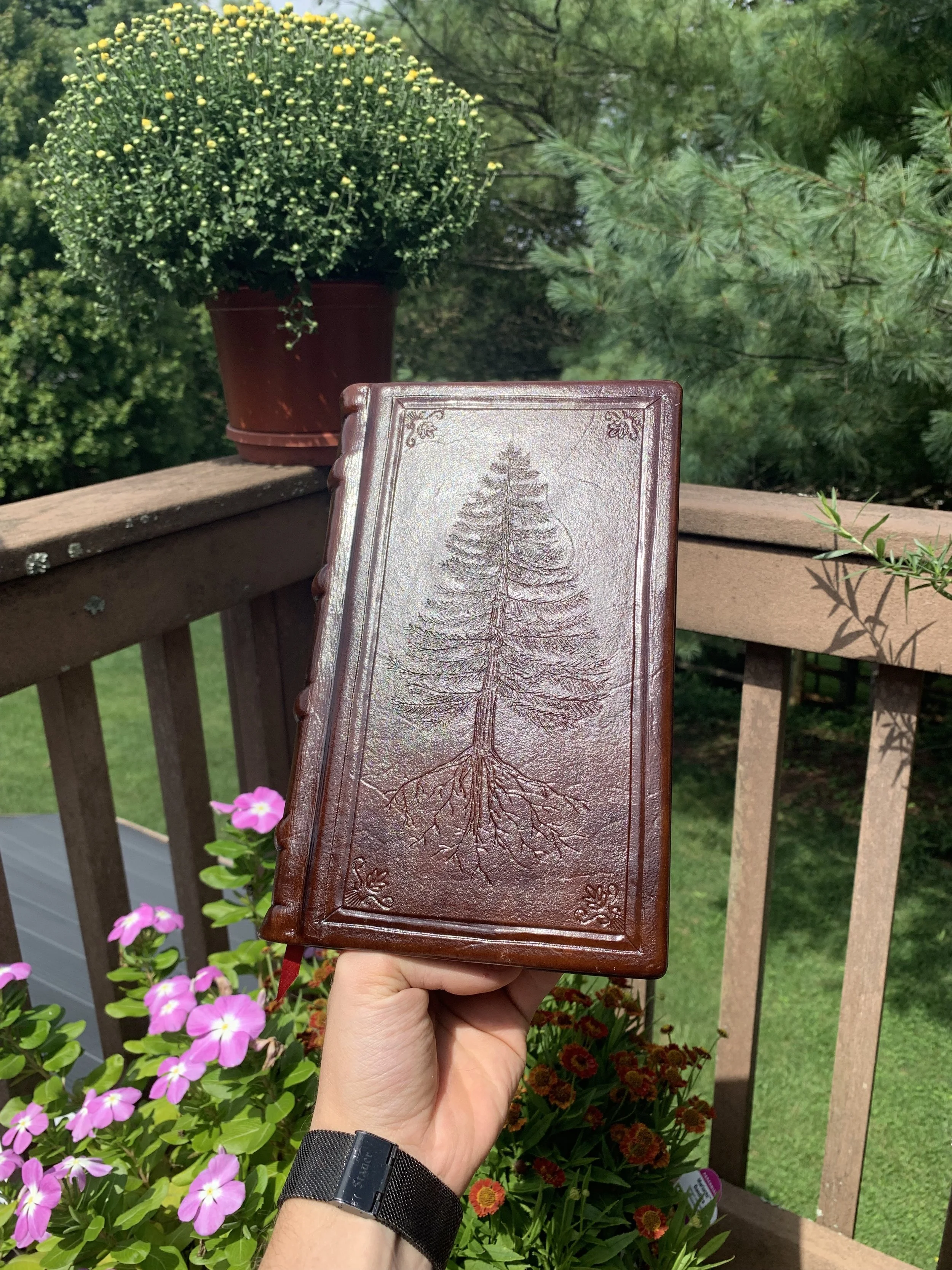 A pine tree themed hand bound book made out of paper and veg tanned leather. Sold on Etsy.