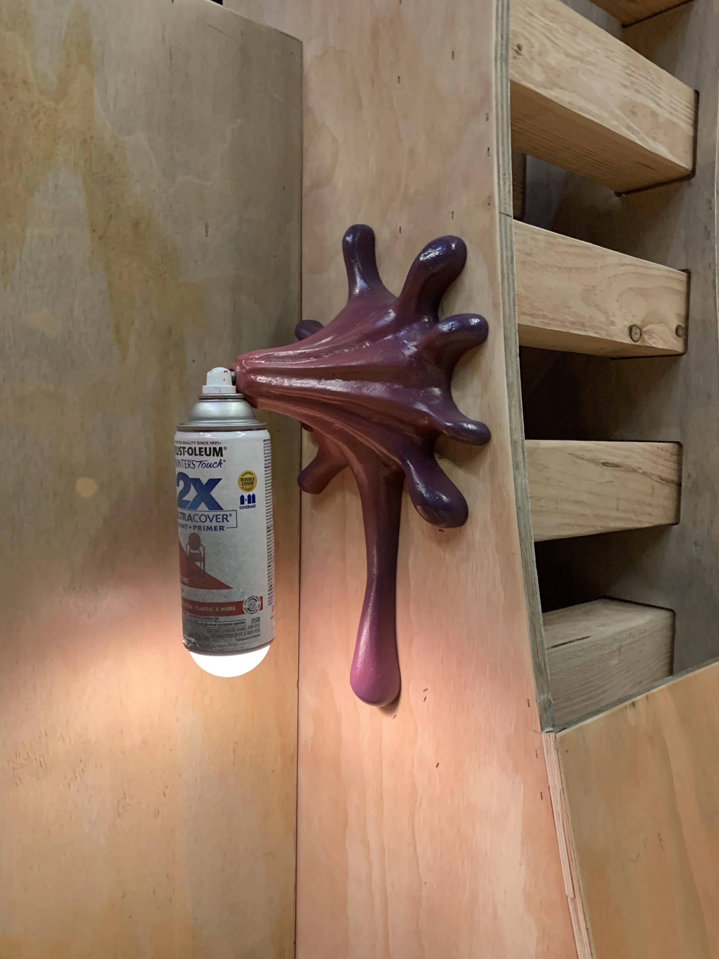 A wall sconce made out of pink foam and a spray paint can for a production of Hip Hop Anansi at the University of Maryland. 