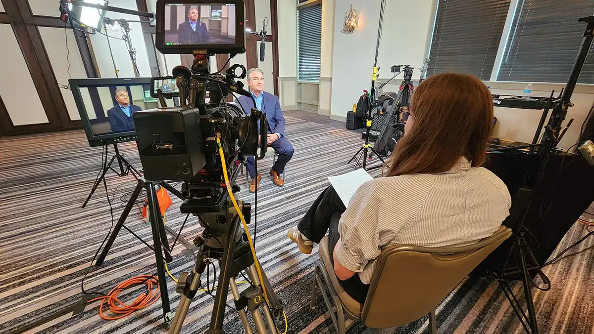 Acclaim Media camera crew filming a customer testimonial at a corporate user group event
