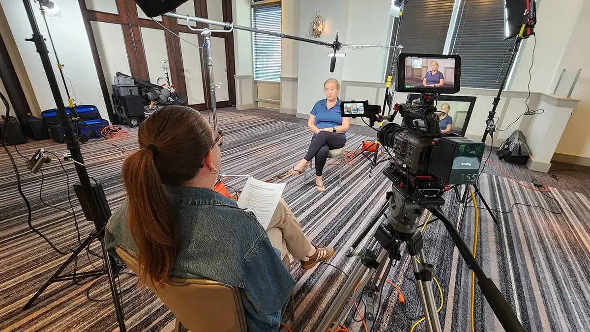 Acclaim Media camera crew filming a customer testimonial at a corporate user group event
