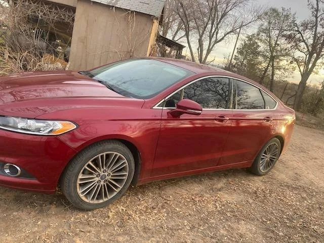 Red sedan completely repaired after collision. all dents are repaired and paint is matched perfectly.