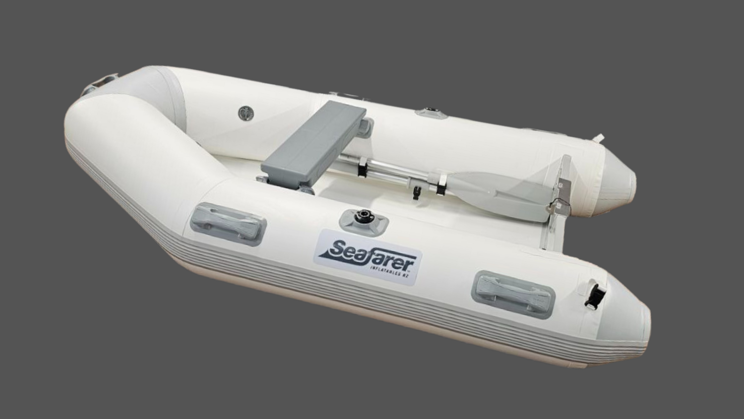 White inflatable boat with a gray seat and oars on a gray background.