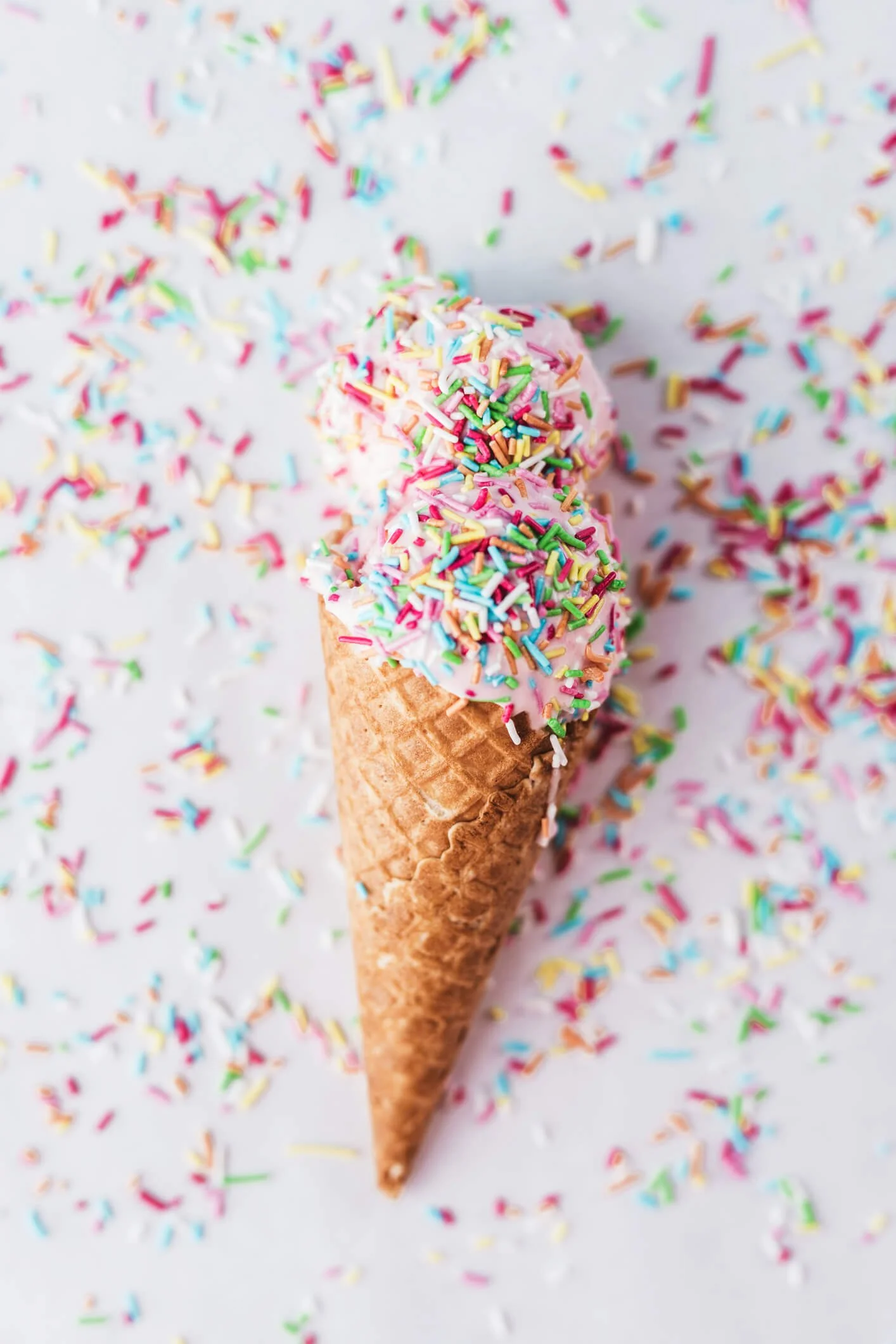 Pink ice cream cone with sprinkles, symbolizing the retro charm and fun of our unexpected party rental upgrades