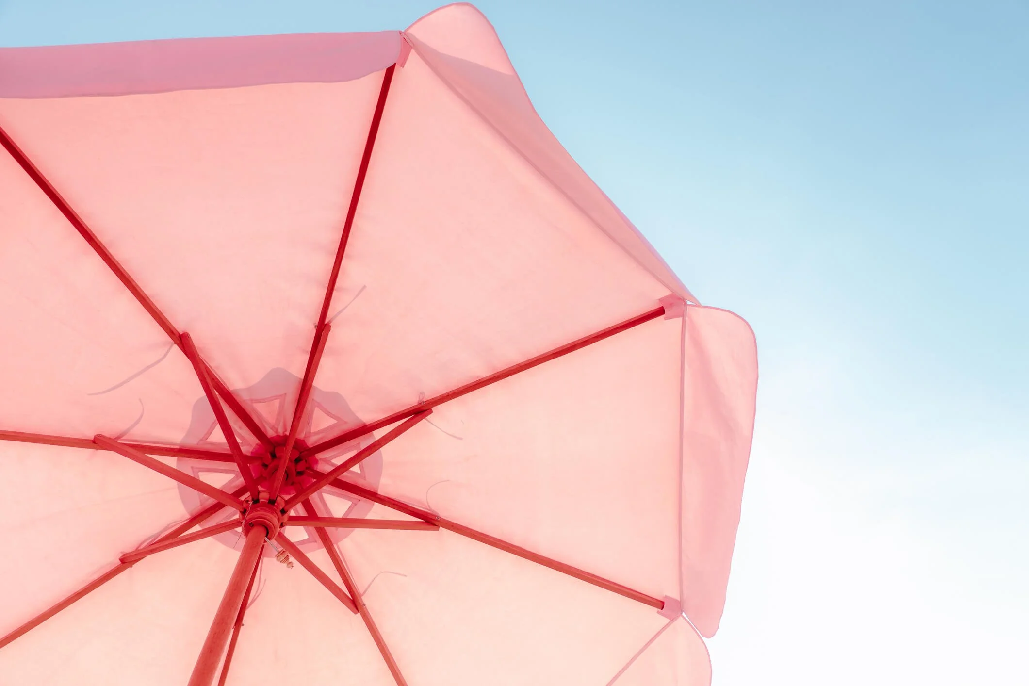 Inviting light pink umbrella providing shade at a foam party, part of unique rental options available