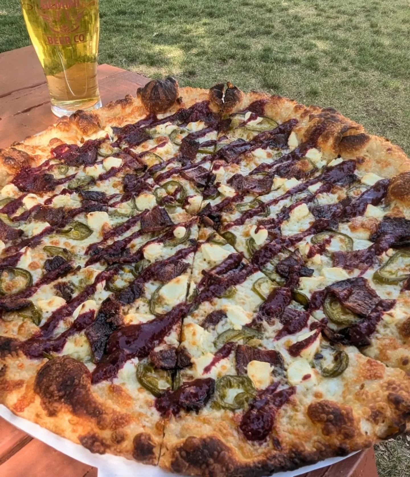 This week's special is the Jalapeno Popper! Bacon, bus-pickled jalapenos, cream cheese, and a raspberry chipotle sauce drizzled on post bake. It's definitely still winter Jalapenos, so the heat on this pie right now is pretty mellow. Come give it a s