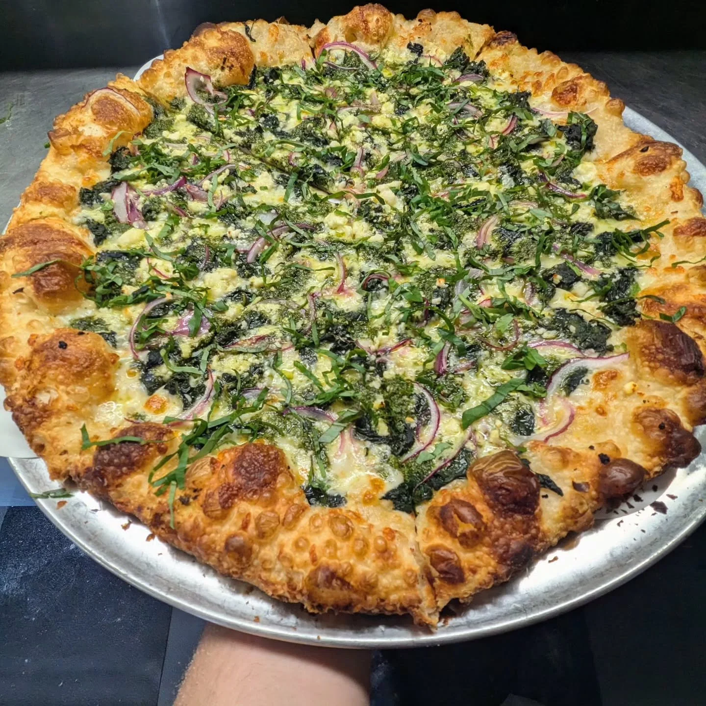 The Green Bastard, from parts unknown. This is one of my all time favorite pies, the origins of this combo go back to  my first pizza job; with a few twists and turns that I've learned at other shops over the years. Pesto, spinach, red onion, feta, f