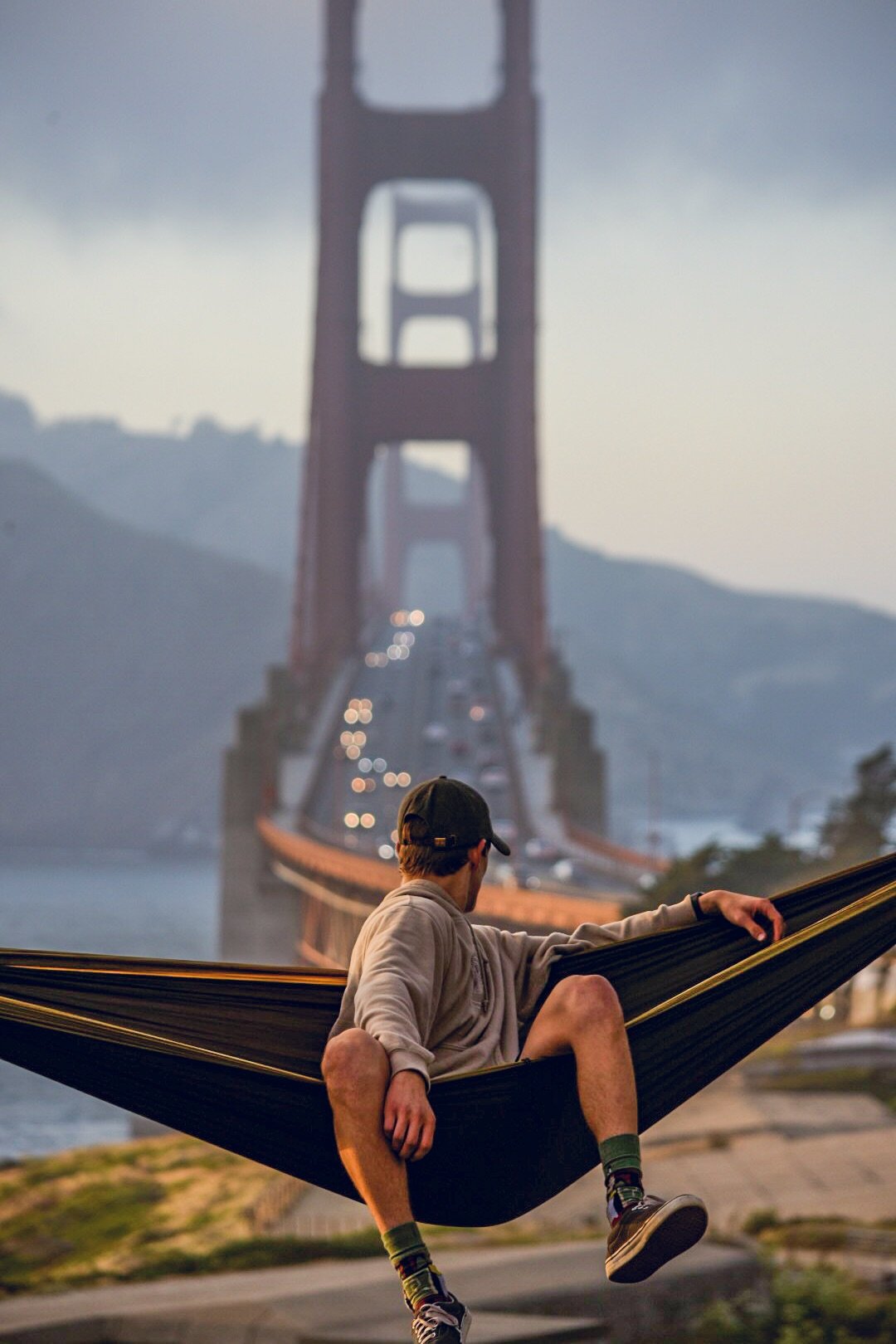 Person sitting in a hammock with the Golden Gate Bridge in the background.