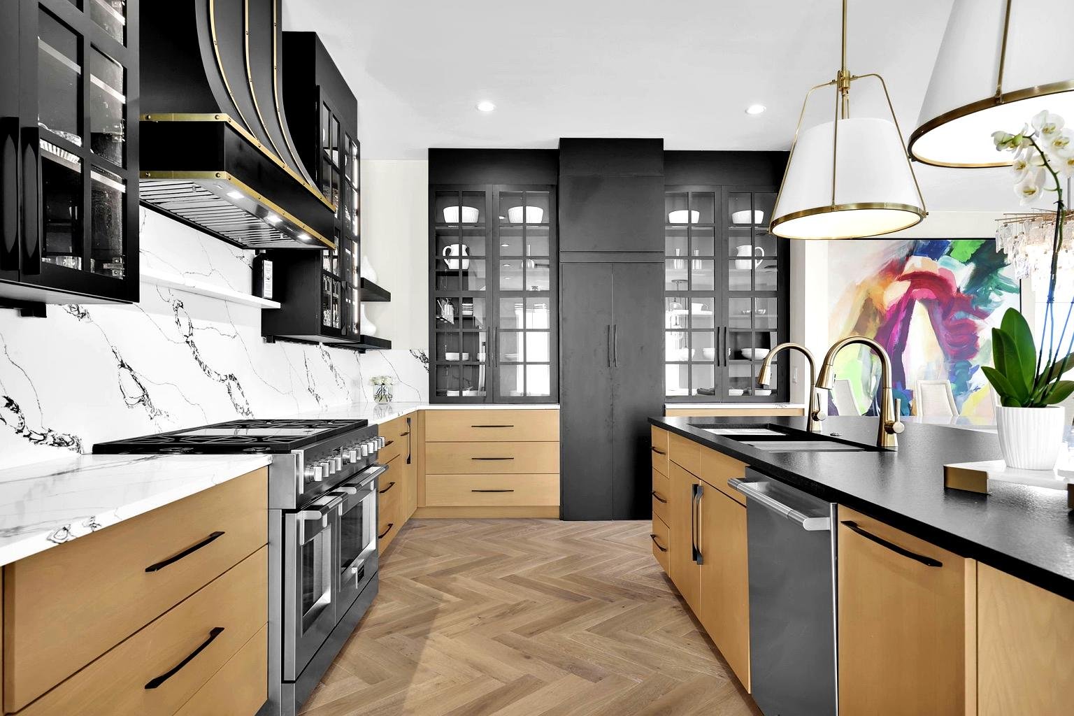Modern kitchen with black and wooden cabinets, marble backsplash, stainless steel appliances, dual sinks, and colorful wall art.