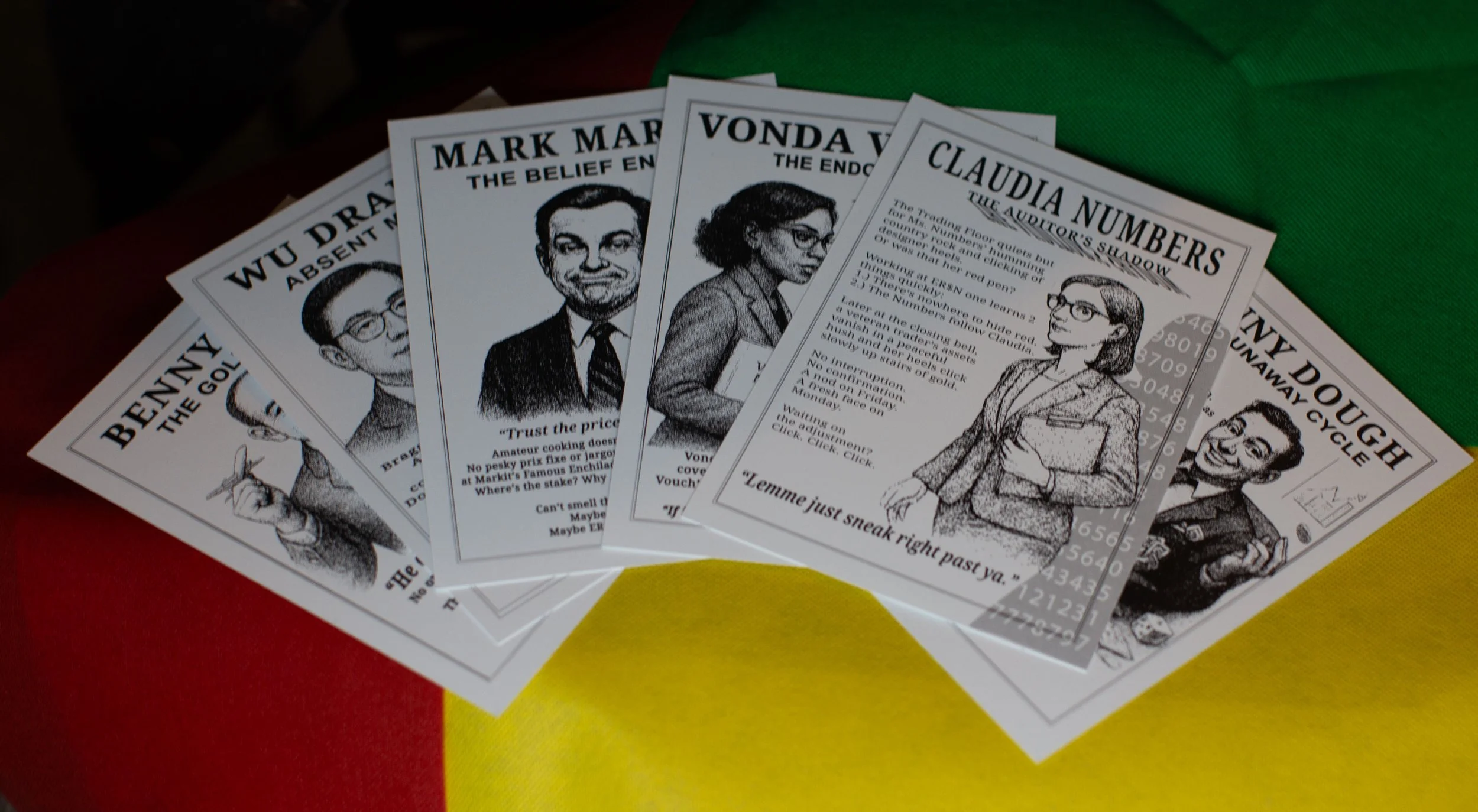 A collection of illustrated newspaper pages with caricatures of people, spread across a colorful surface.