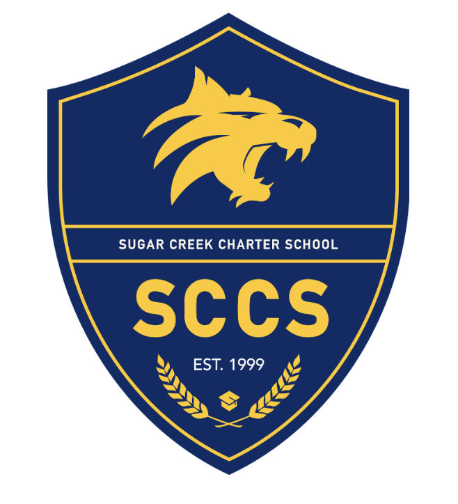 A school emblem shield with a yellow lion's head on a blue background, the words 'Sugar Creek Charter School', 'SCCS', and 'EST. 1999', with yellow laurel branches at the bottom.