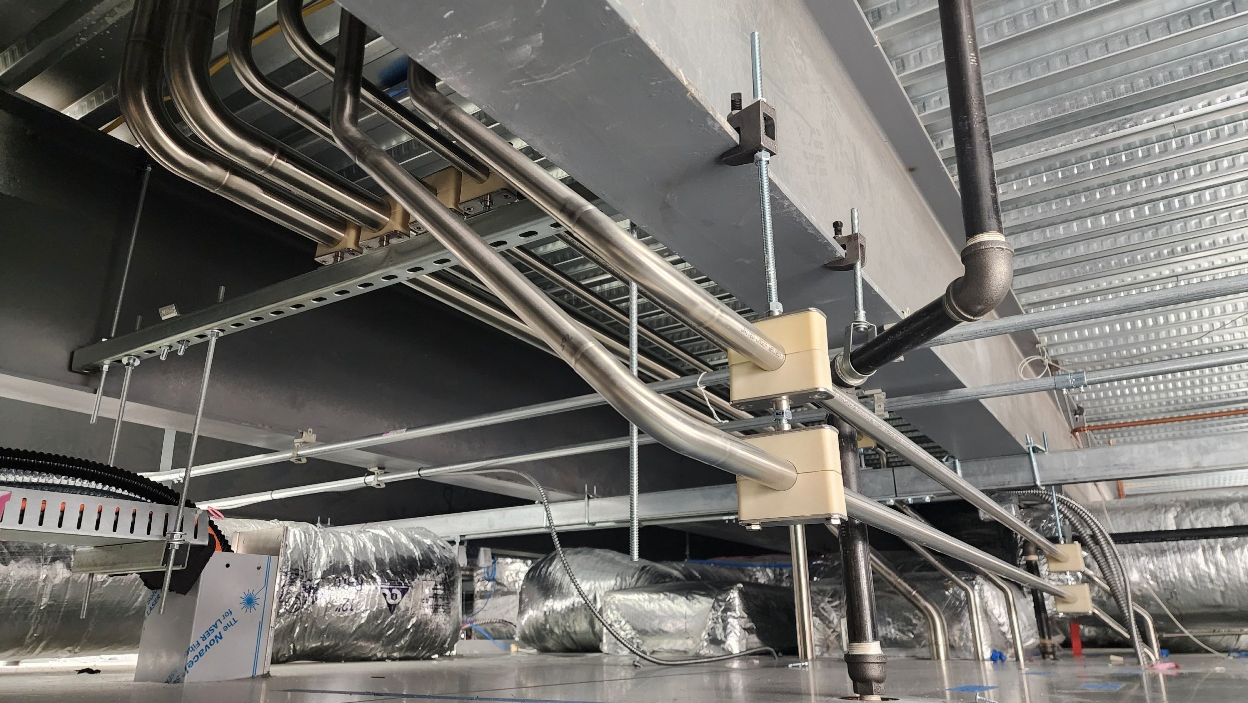 1in Sanitary tubing installed from Mezzanine, through plenum, and into clean room drop.