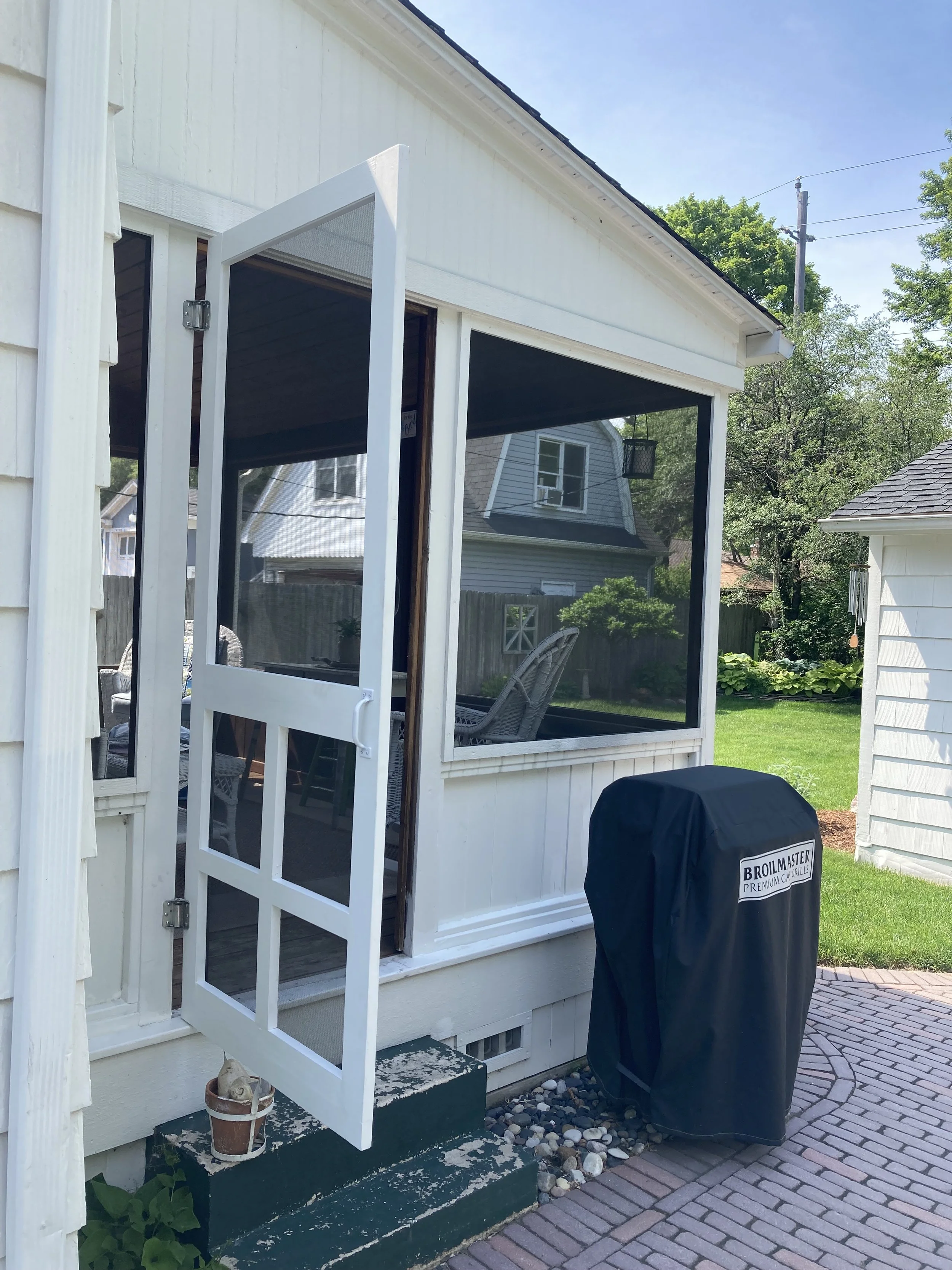 Patio door repair and screen door project for backyard porch entrance.