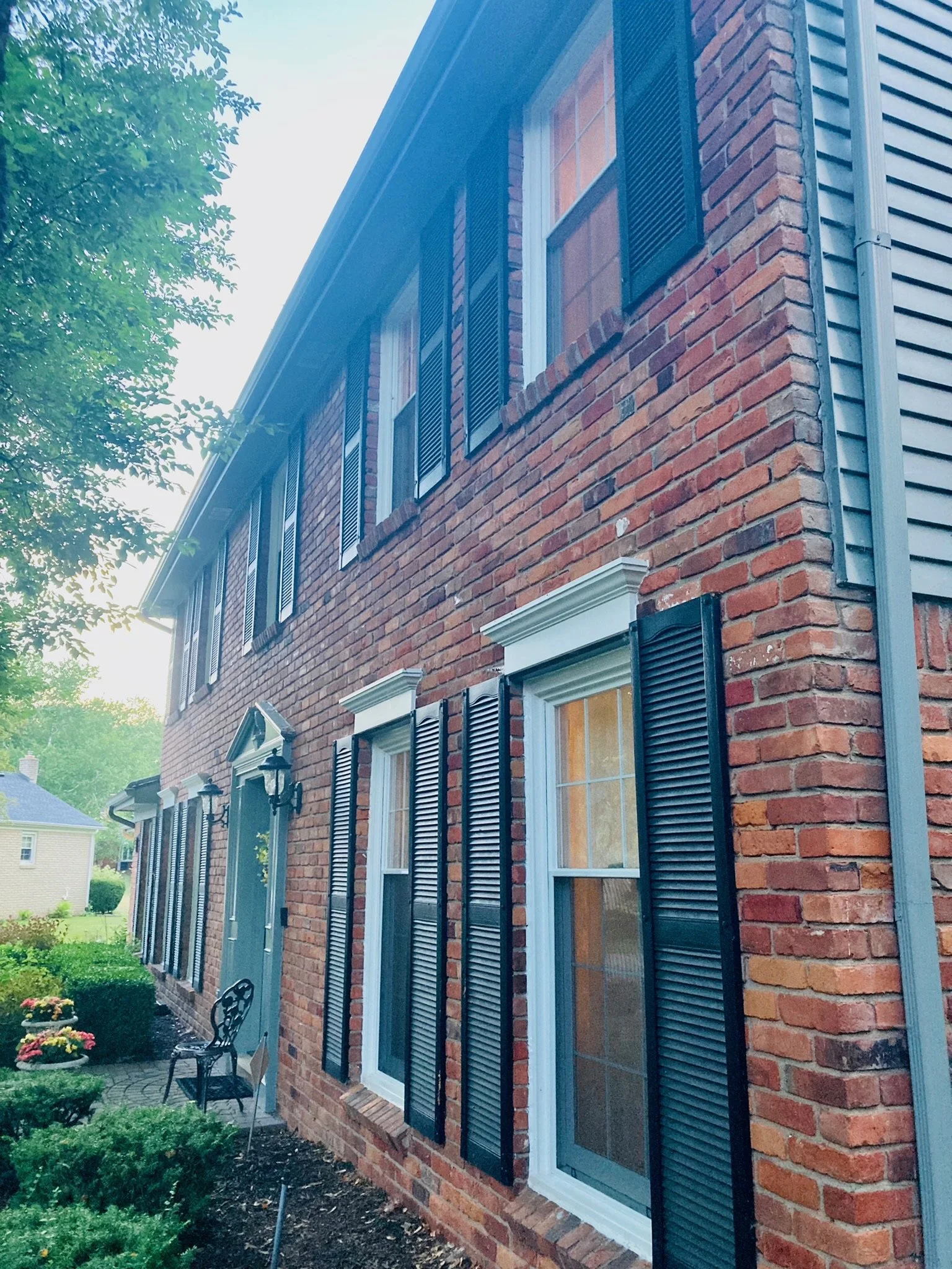 Brick home with screened windows and fitted screen inserts
