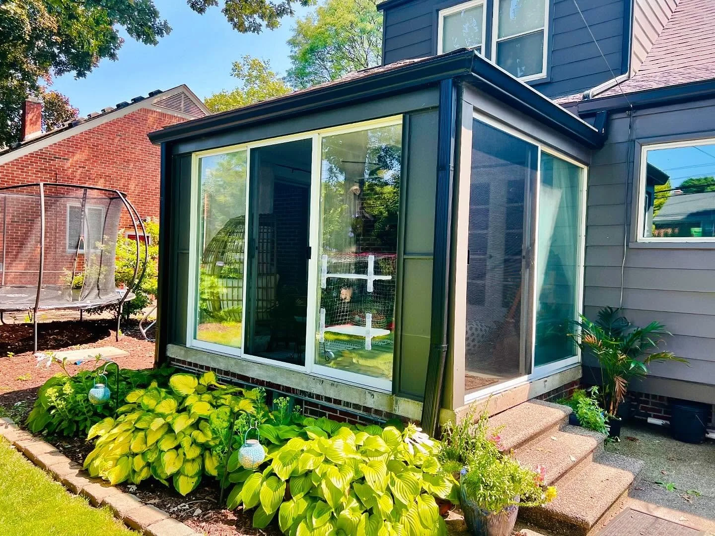 Custom screened enclosure attached to a residential home