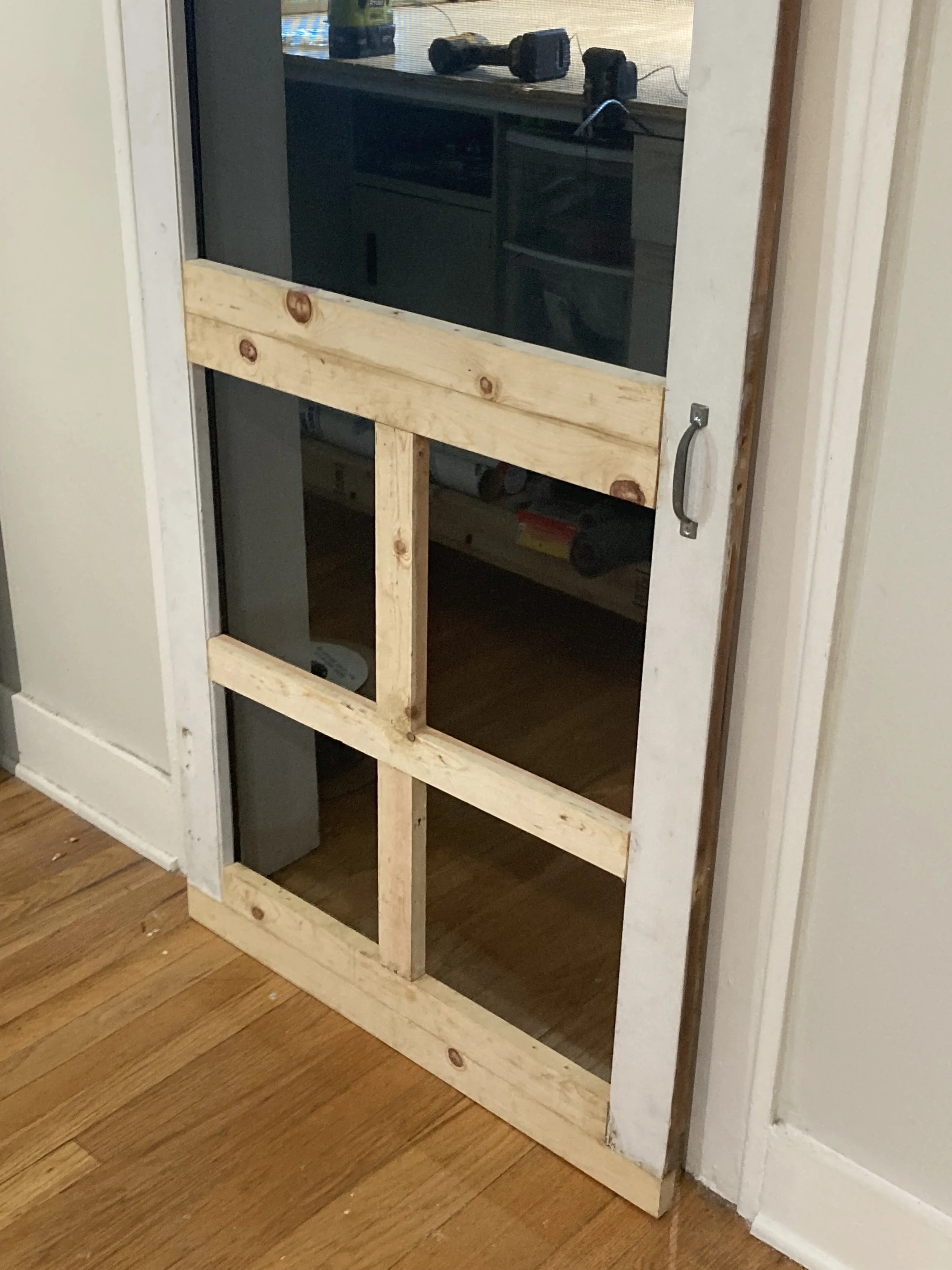 Wood door restoration and repair with new wood supports and repaired door frame trim.