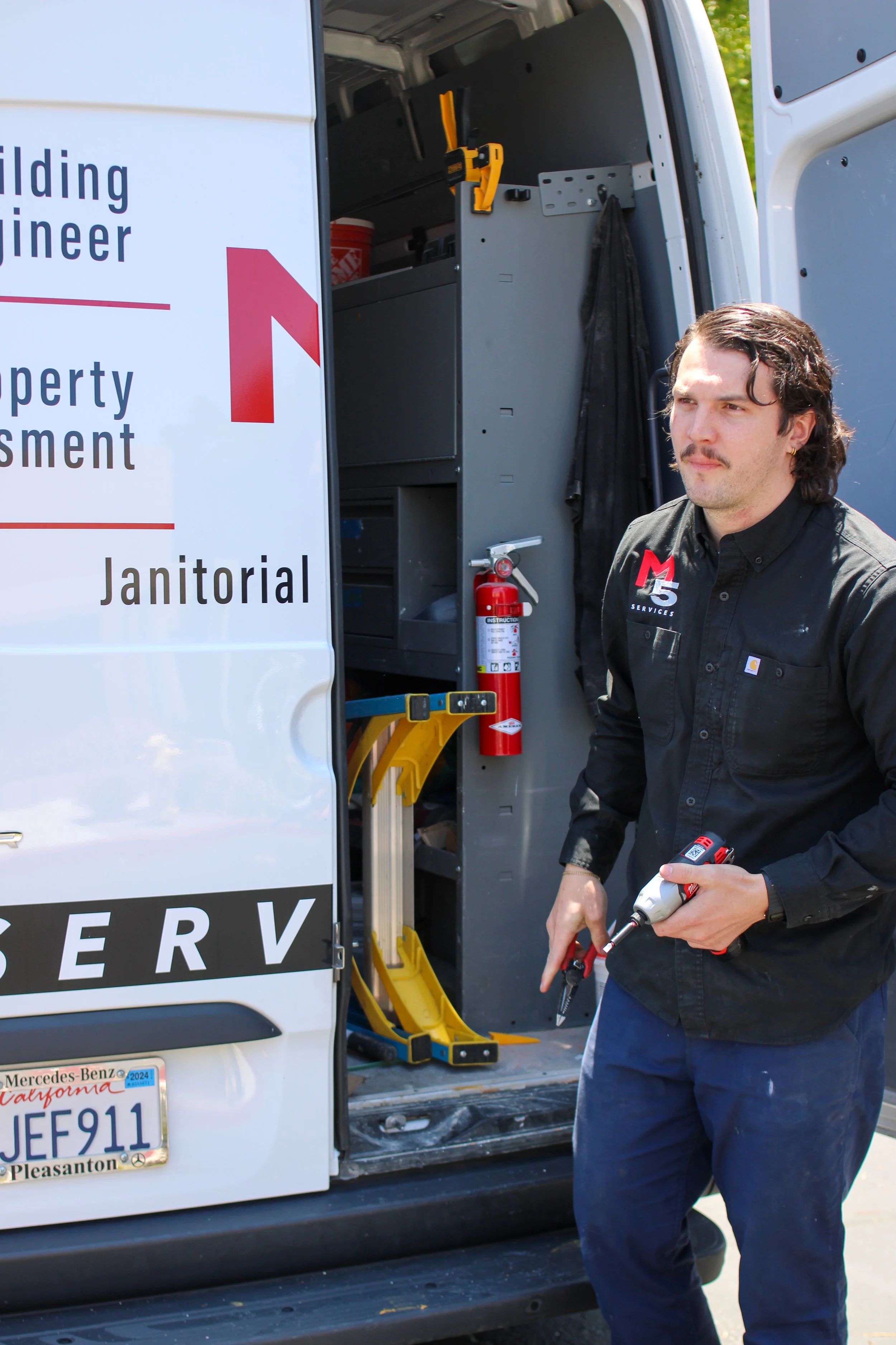 M5 Service tech pulling tools out of his van for a full service maintenance request