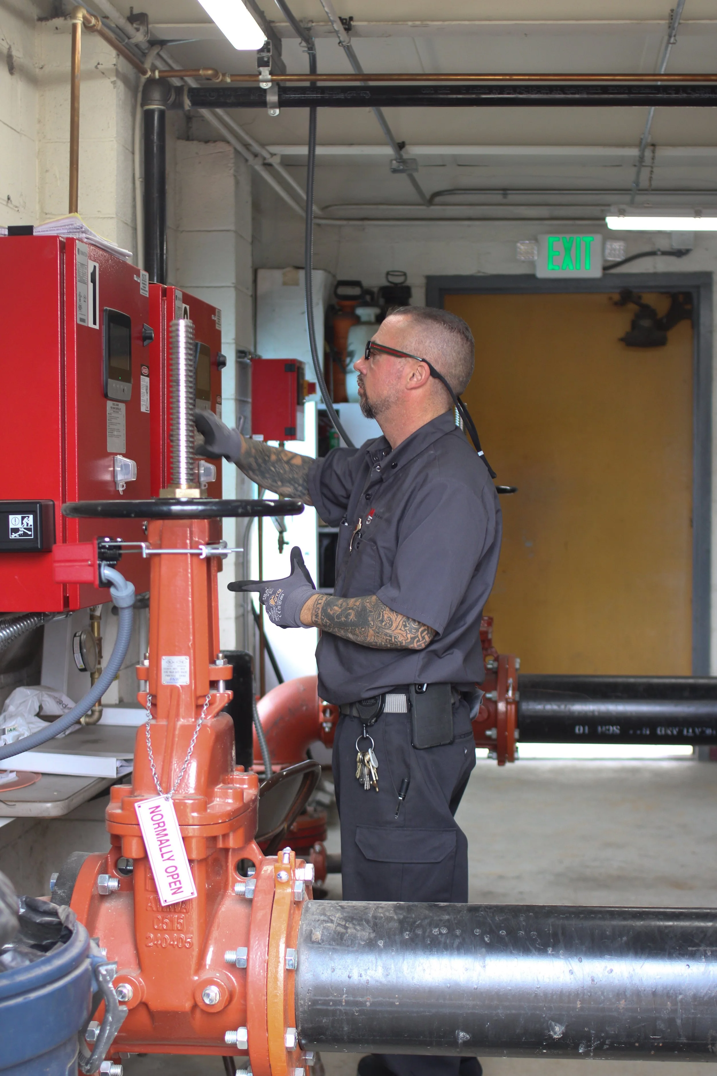 Chief Engineer inspecting a buildings fire life safety system at Gate 510