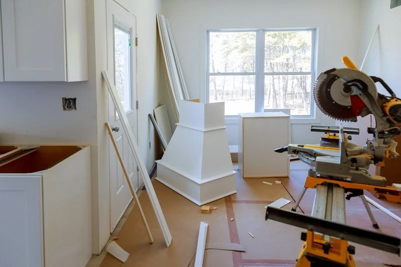 Homeowners reviewing renovation plans while living through a kitchen remodel